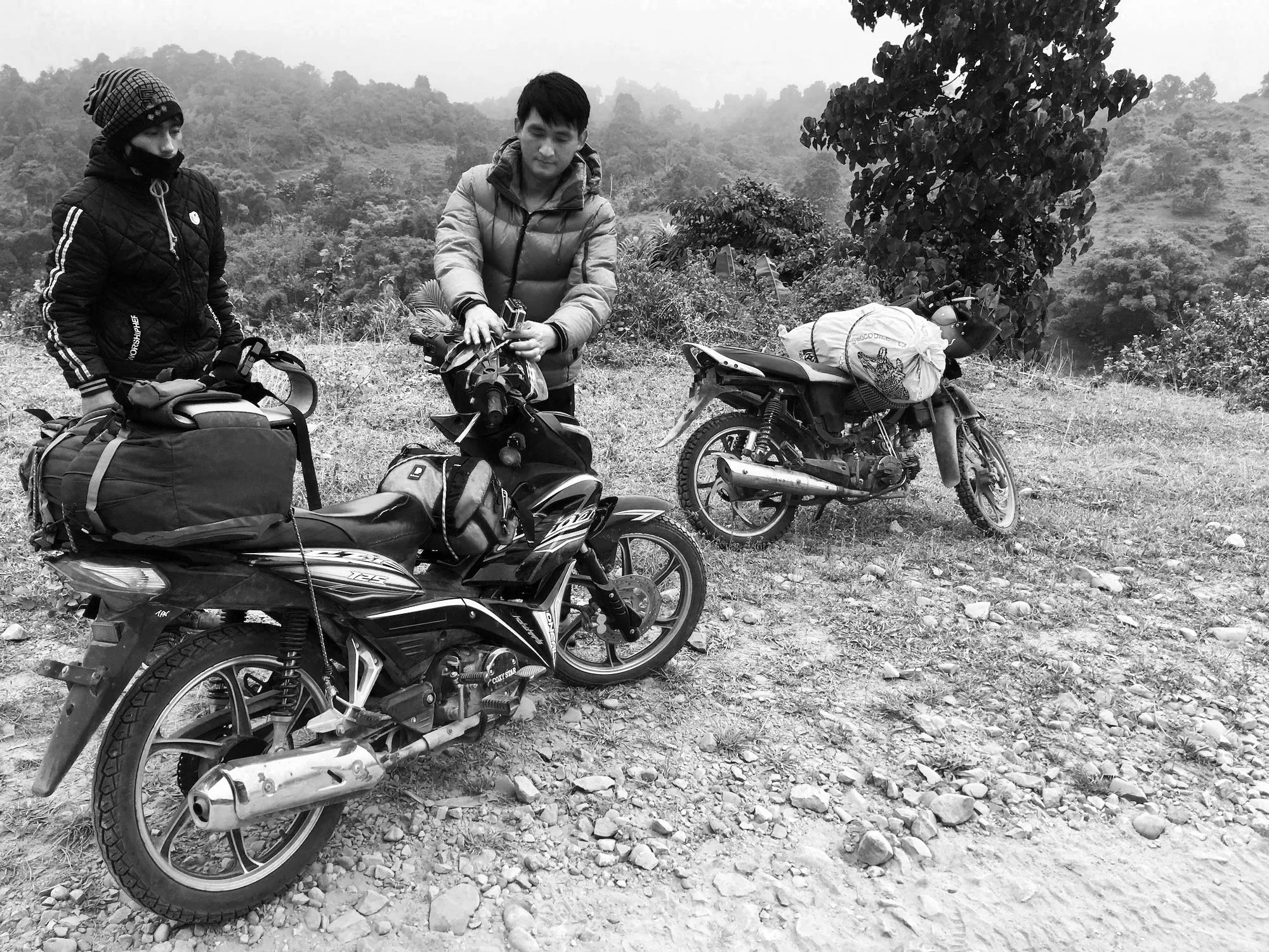 My guide, Aung, loading up the motorbikes.