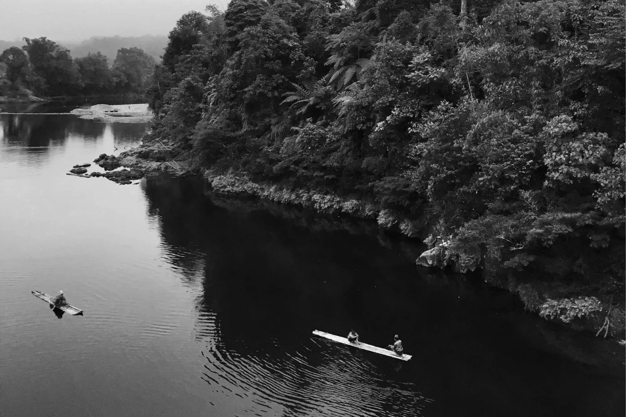 Small bamboo boats on the river through the jungle.