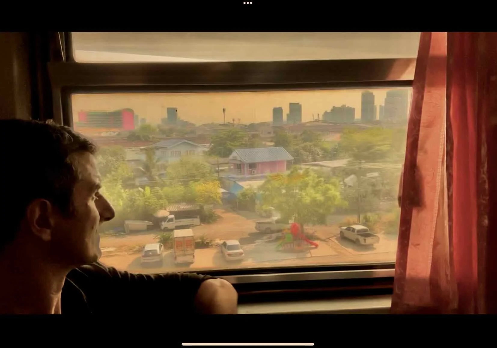 The author looking out of the train window leaving Bangkok.