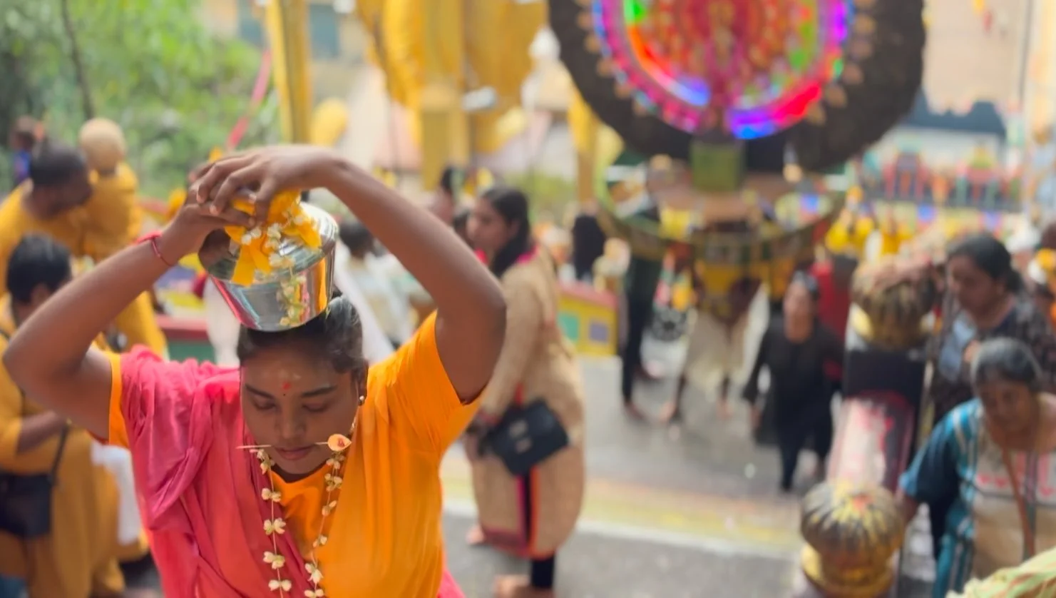 A Thaipusam pilgrim with a skewer through her cheeks.