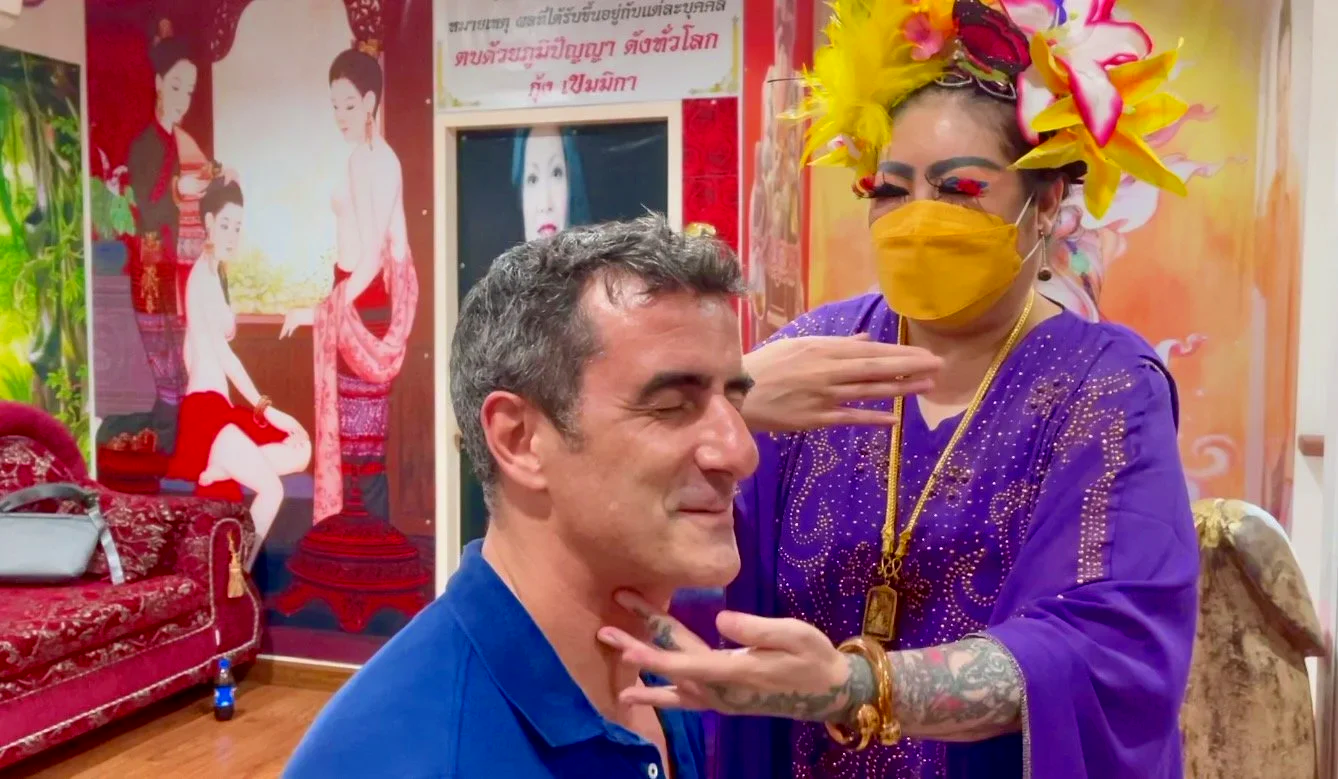Khun Khemika administering her slapping therapy to the author.