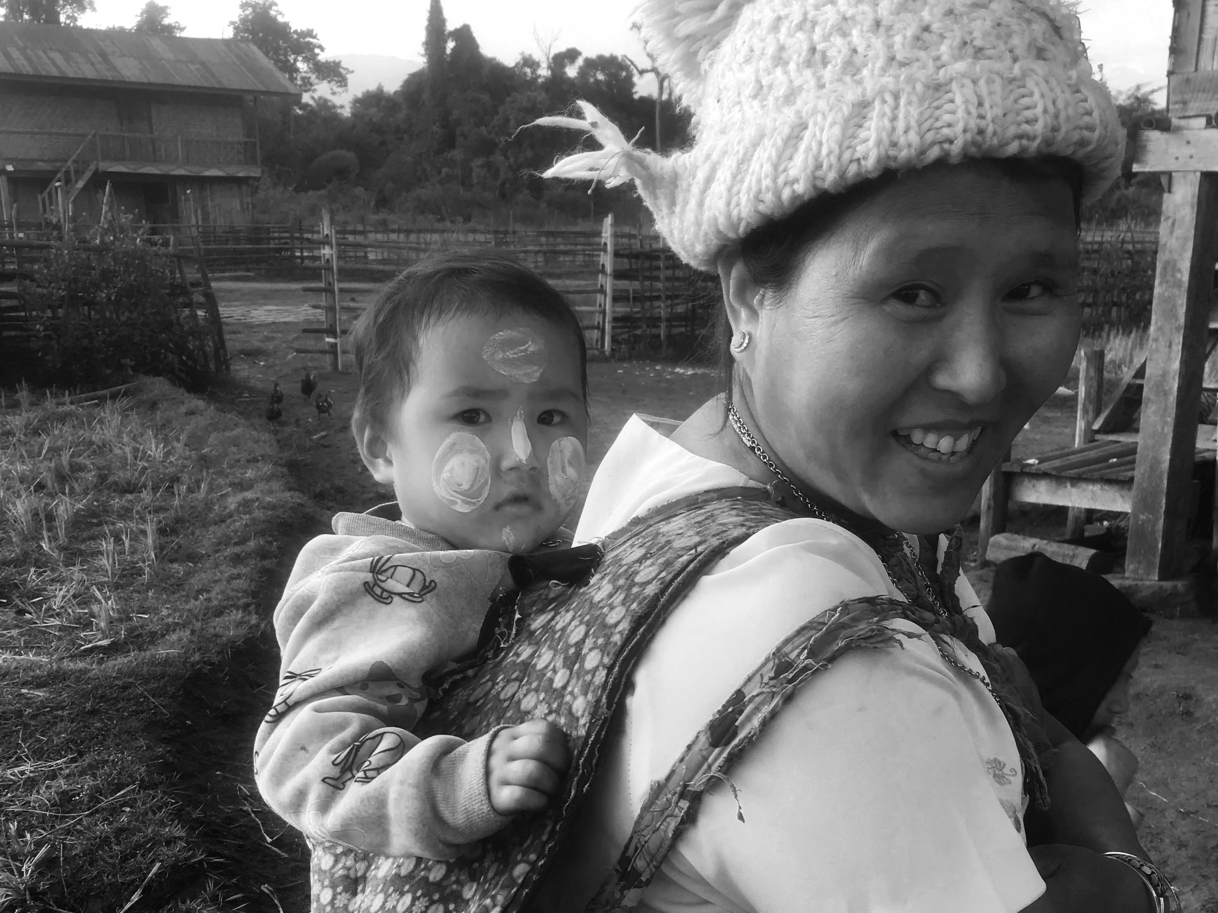 Local woman carrying a baby on her back.