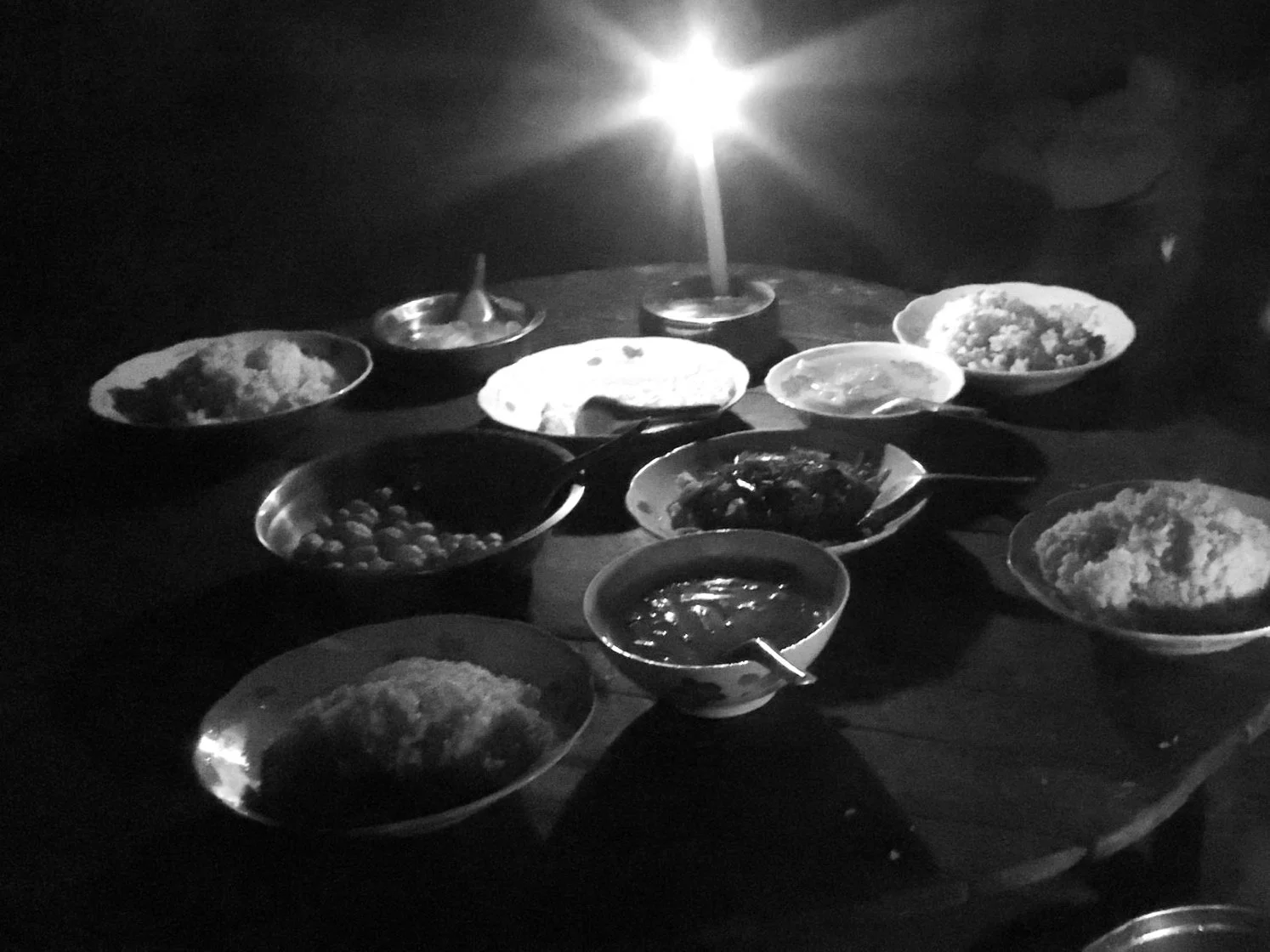 A selection of local dishes on a candlelit table.