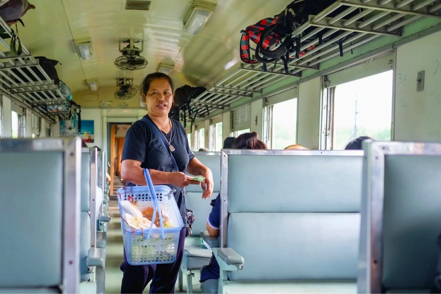 Food vendor walking down the train carriage.