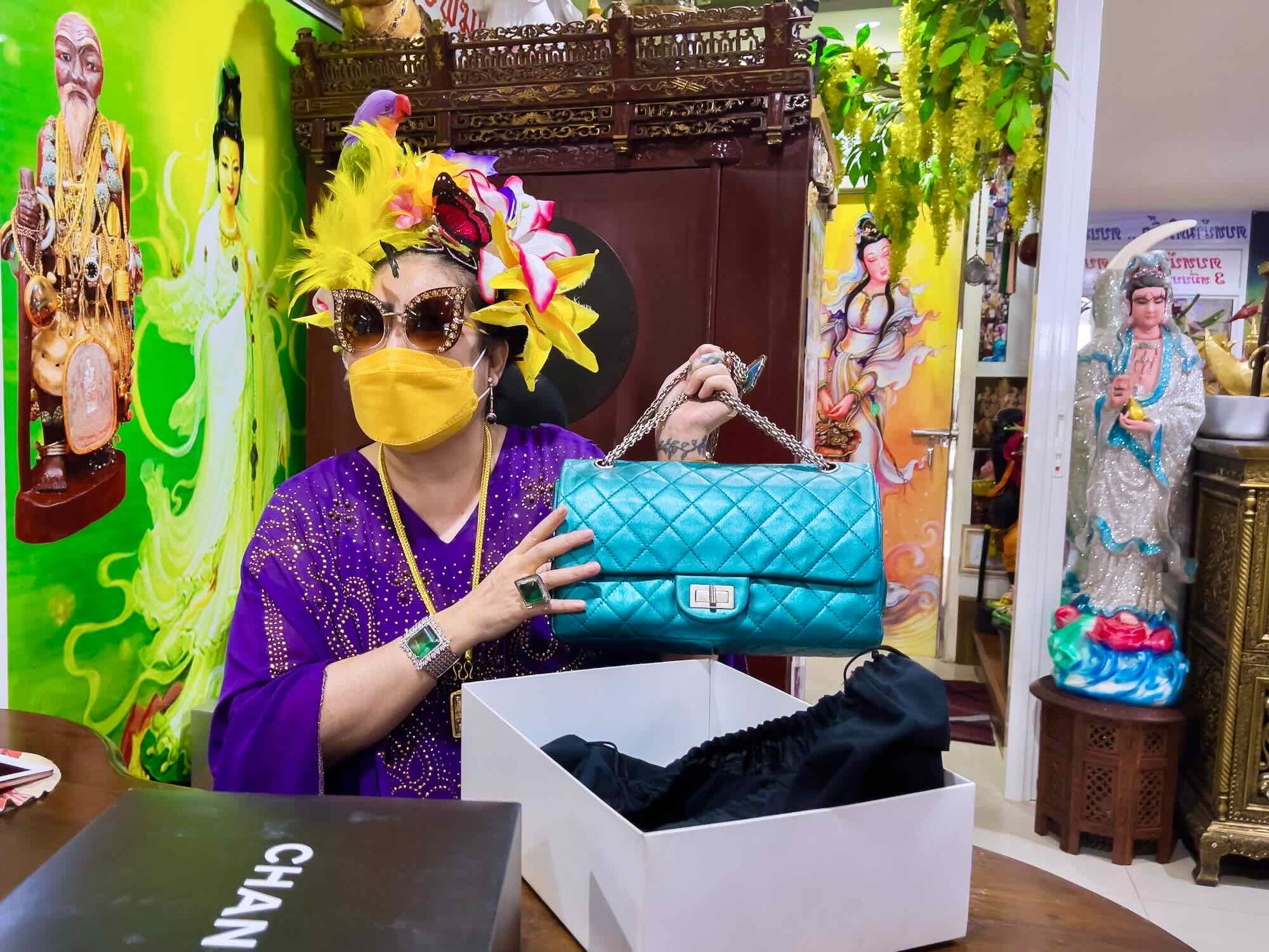 Khun Khemika showing off one of her Chanel bags.