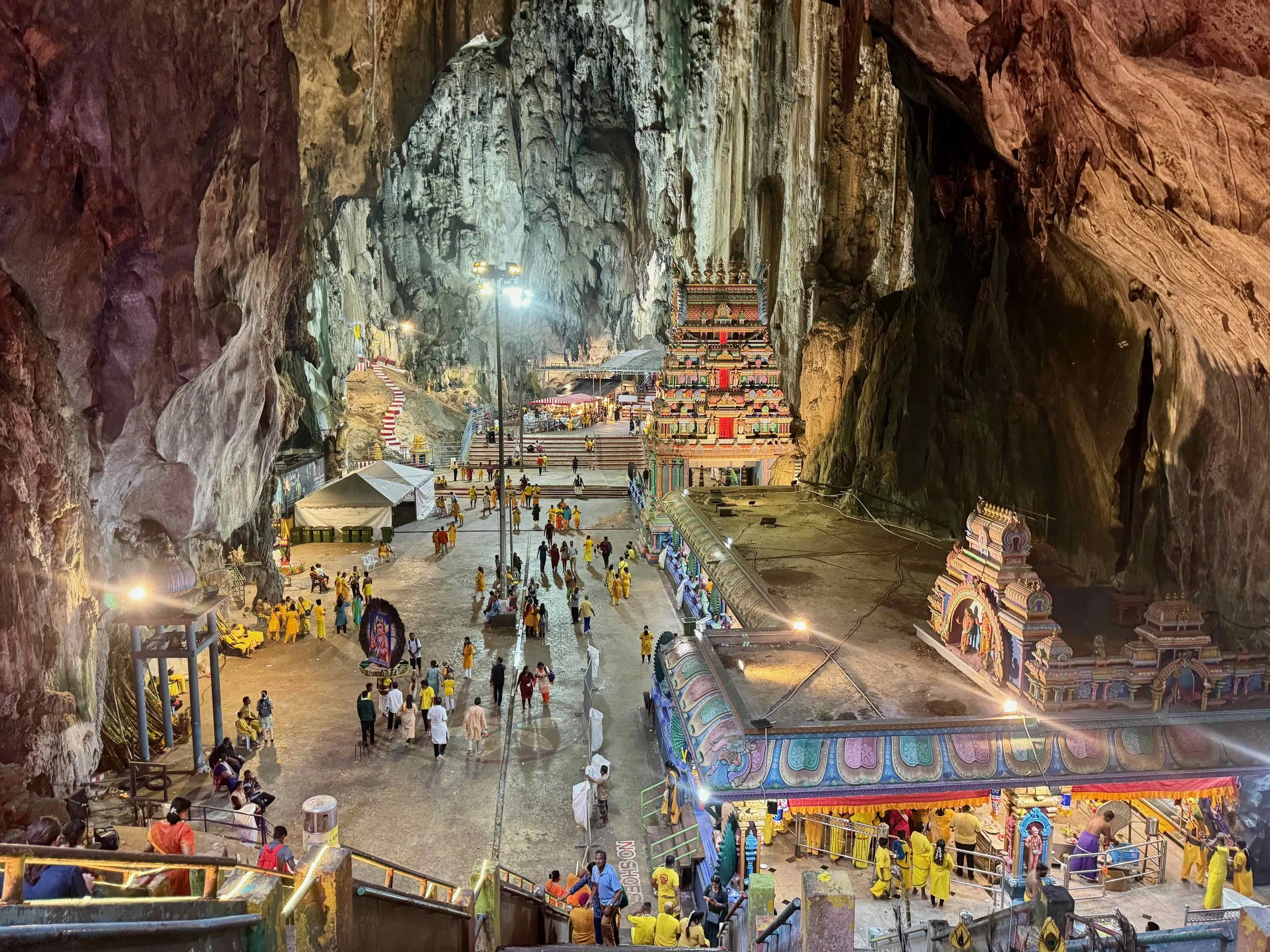 Thaipusam pilgrims reach the Batu Caves where they’re finally relieved of their burdens, or kavadi.