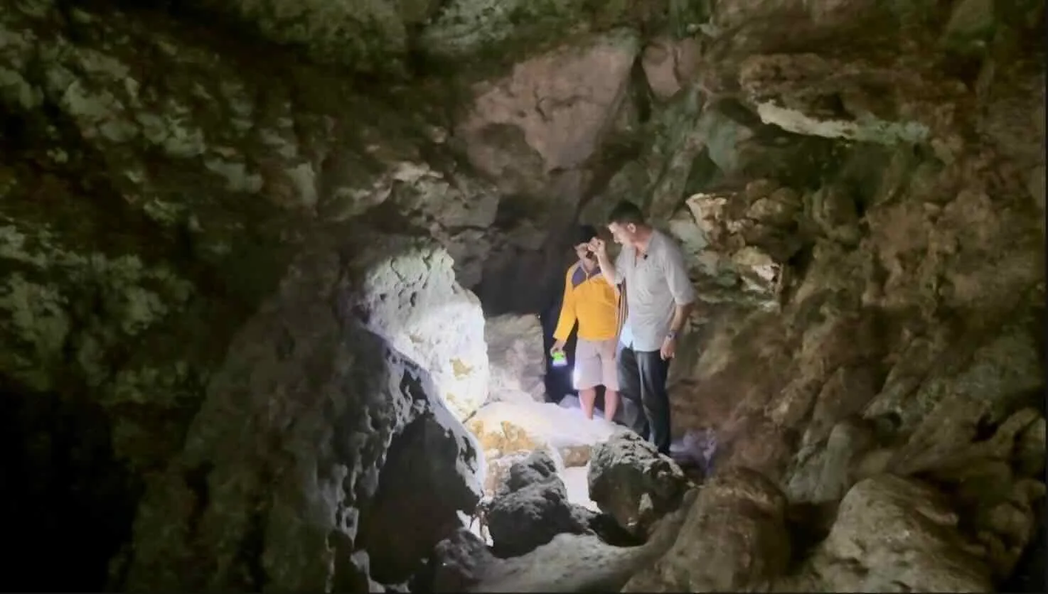 The author exploring the cave by torchlight.