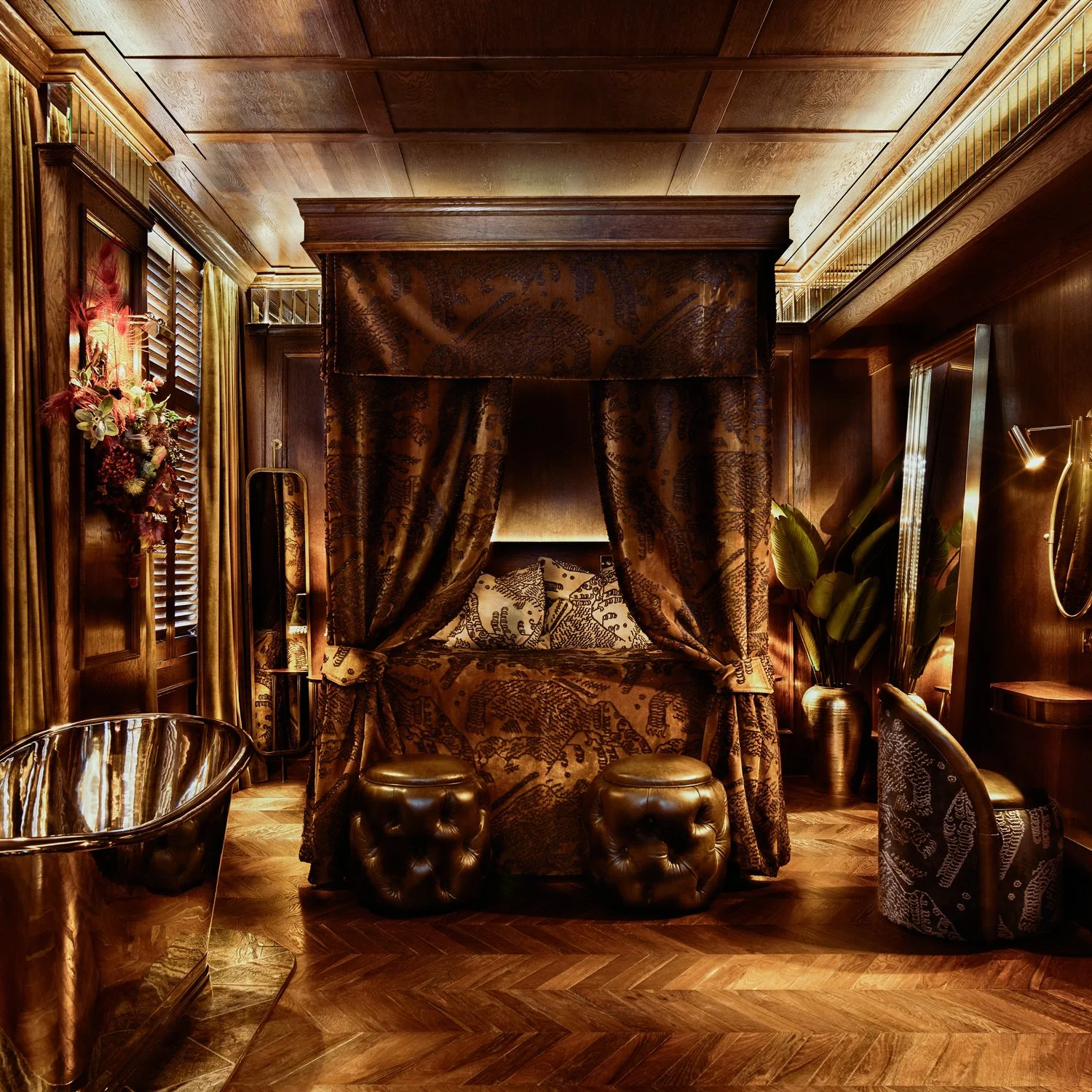 House of Gods boutique luxury hotels in Edinburgh, Glasgow & London. Luxurious bedroom with dark wood walls and ceiling, featuring a four-poster bed with ornate brown and gold drapes and matching pillows.