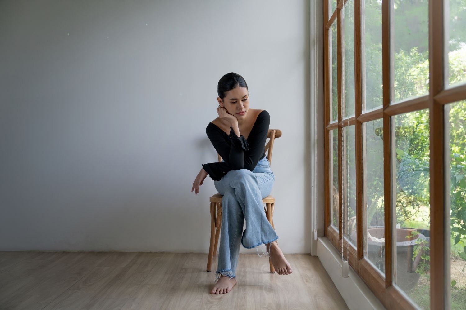 Lady Sitting in Chair Appearing Distant