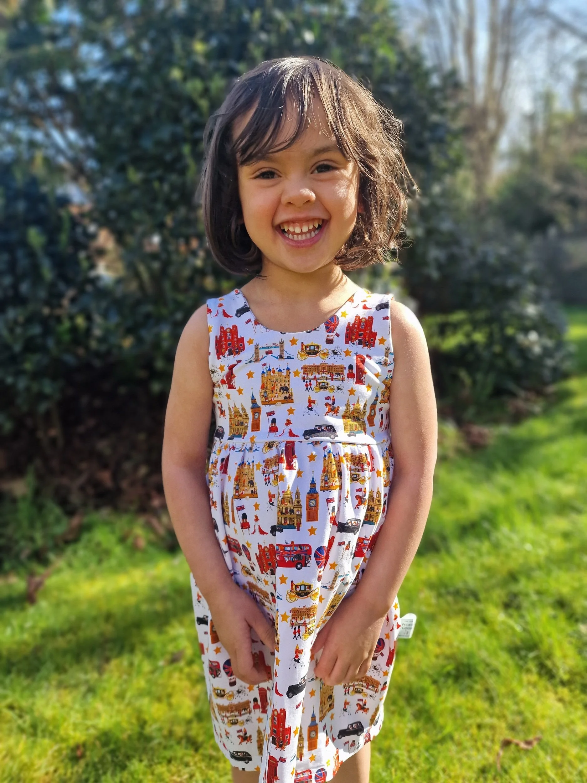 Little girl wearing London dress from luxury British brand Peckish Goose