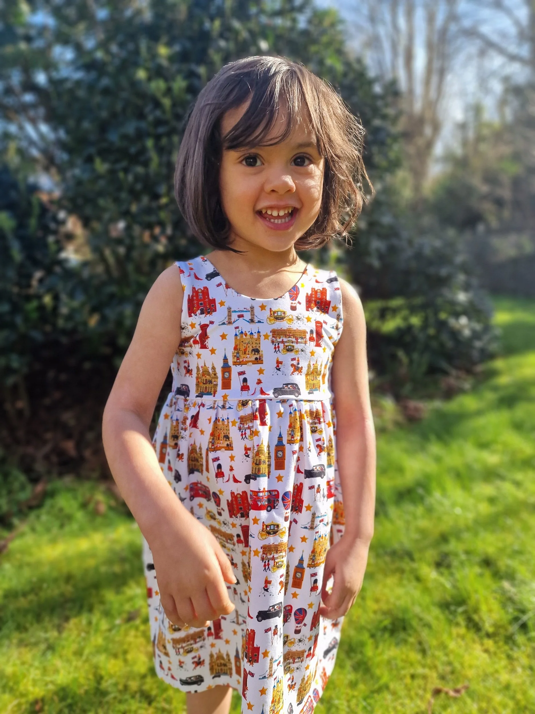Little girl wearing London dress from luxury British brand Peckish Goose