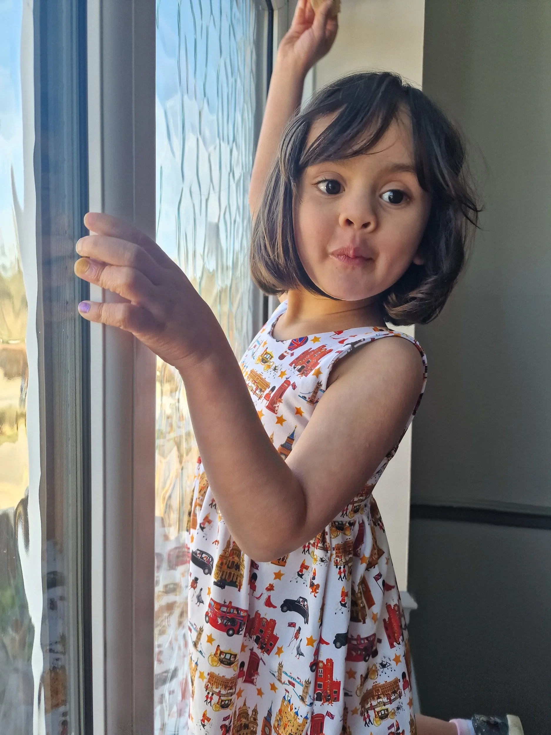 Little girl wearing London dress from luxury British brand Peckish Goose