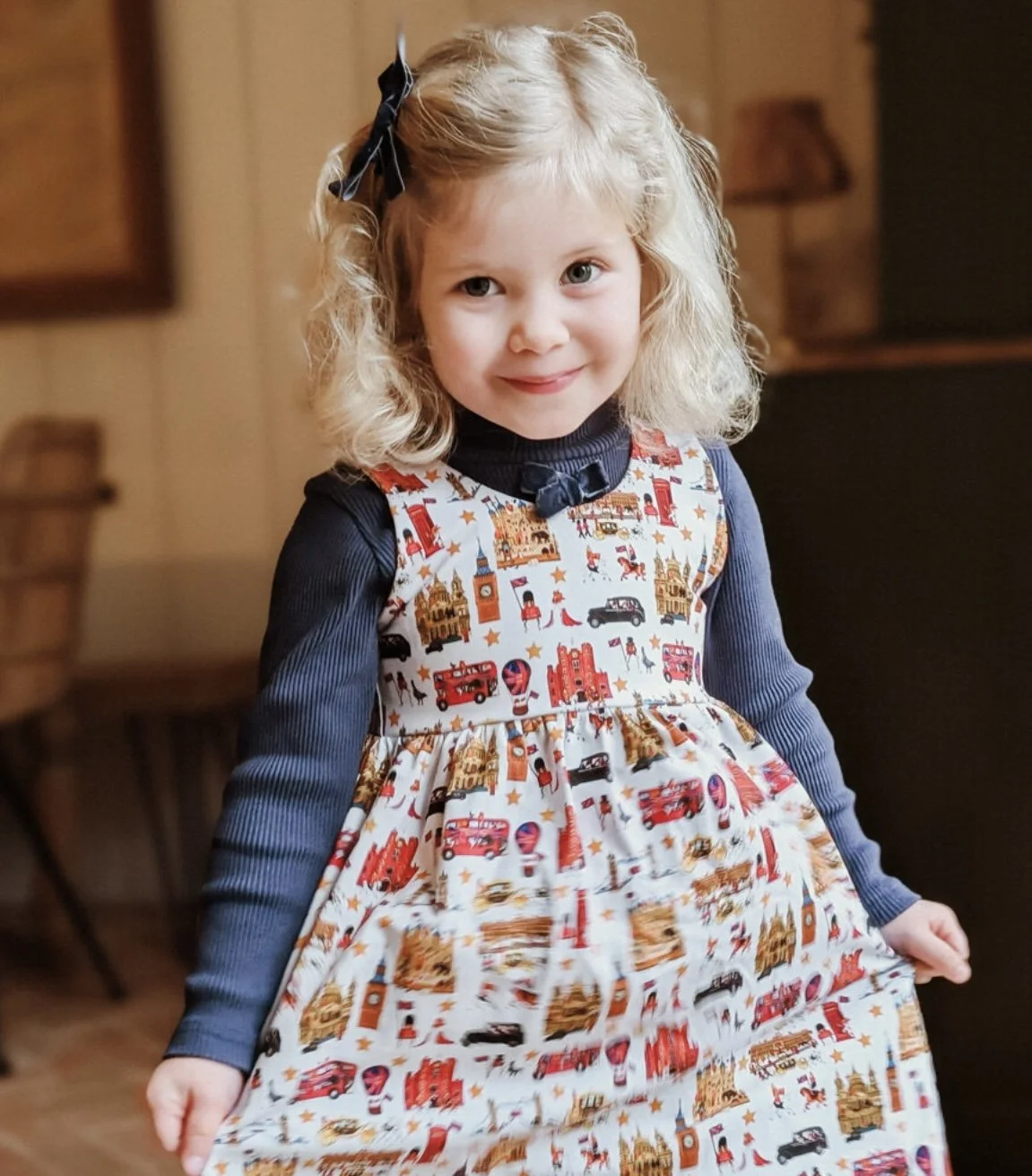 Little girl wearing London dress from luxury British brand Peckish Goose