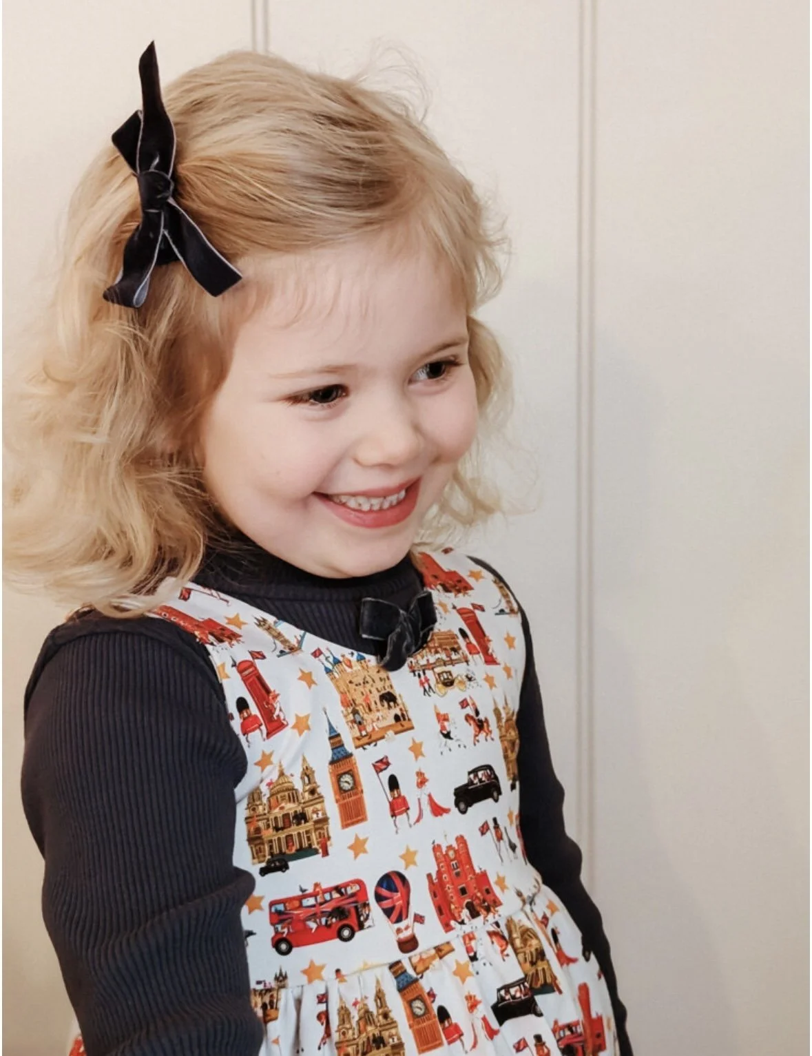Little girl wearing London dress from luxury British brand Peckish Goose