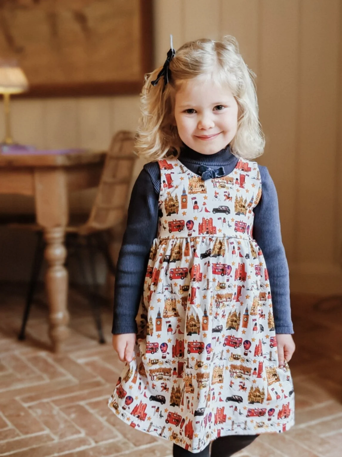 Little girl wearing Peckish Goose London dress.