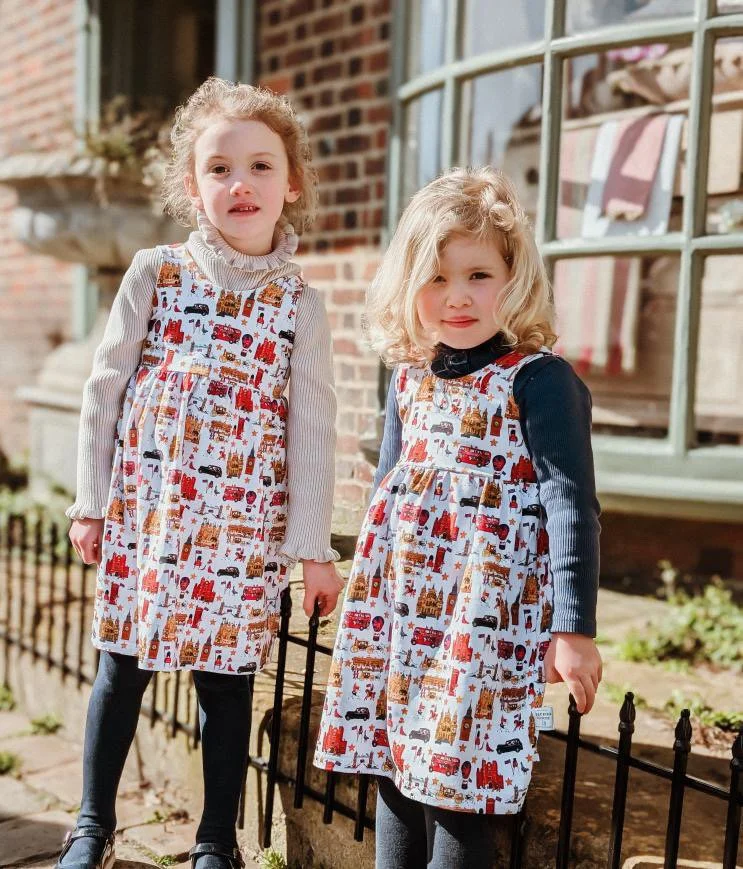 Girls in matching organic dresses in a London British style.  Made in uk.