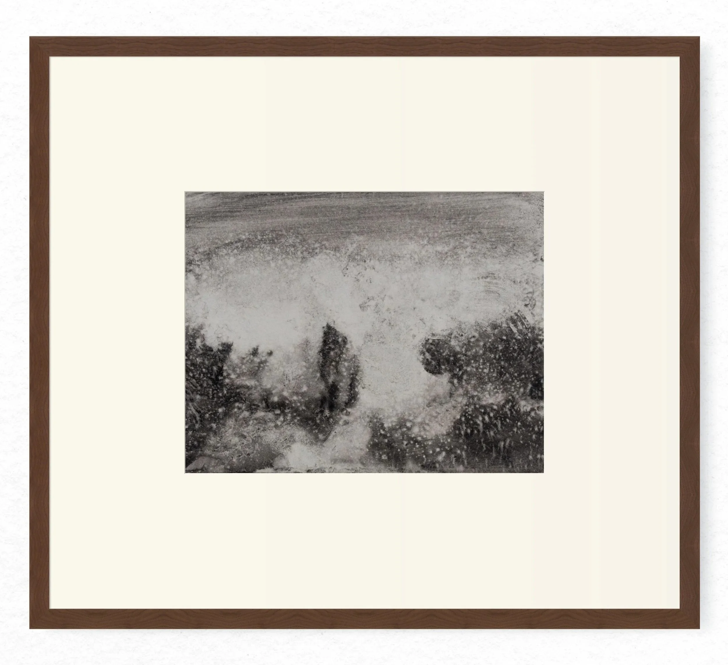 Shore 05 by Nicolas de Jesus — liquid charcoal and water on paper, waves crashing against rocks rendered in pale spray dominating the centre with dark rock masses at the base, hardwood frame with mount