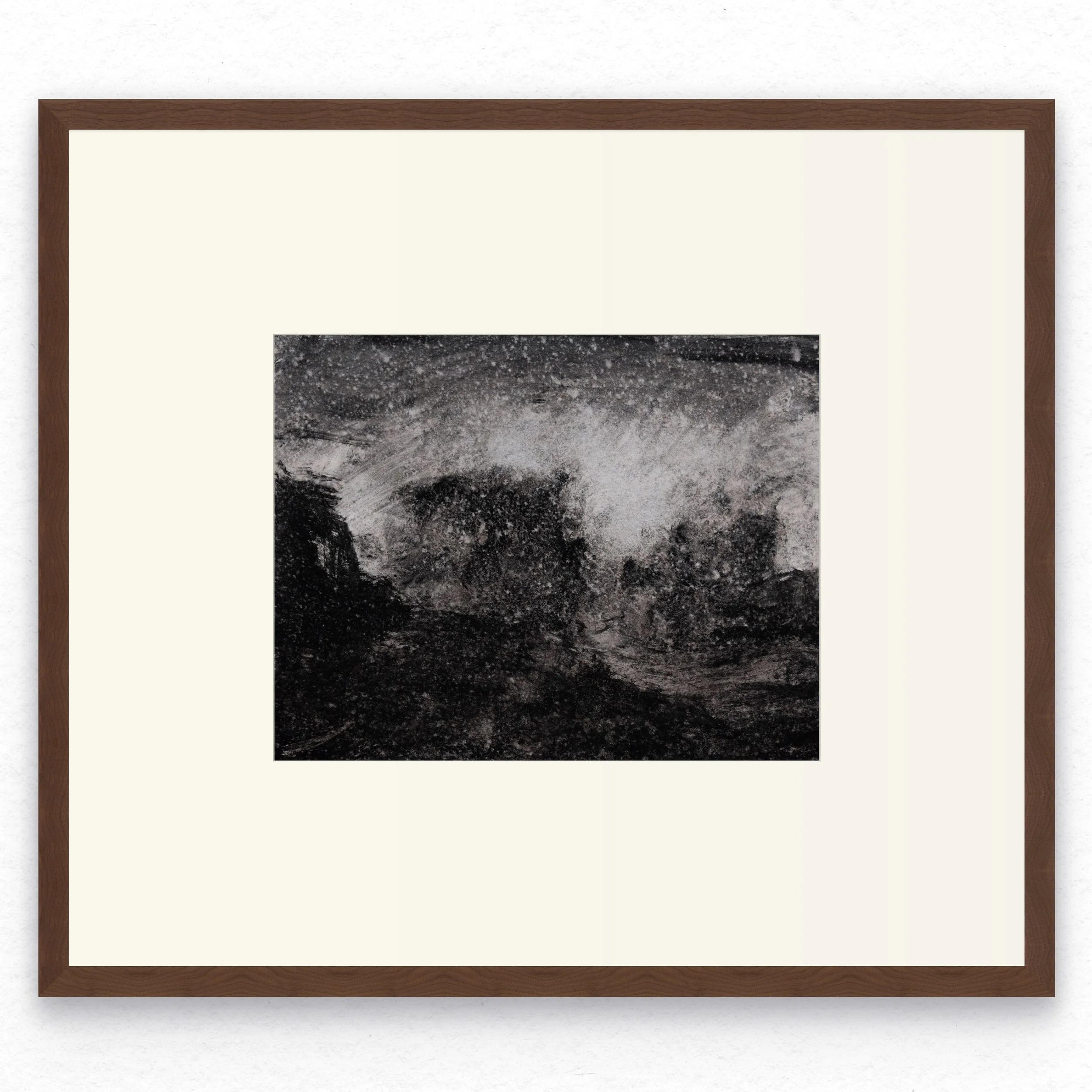 Shore 07 by Nicolas De Jesus — liquid charcoal and water on paper, waves crashing against rocks rendered in dense dark texture across the lower half, with spray rising into a heavily speckled sky, hardwood frame with mount