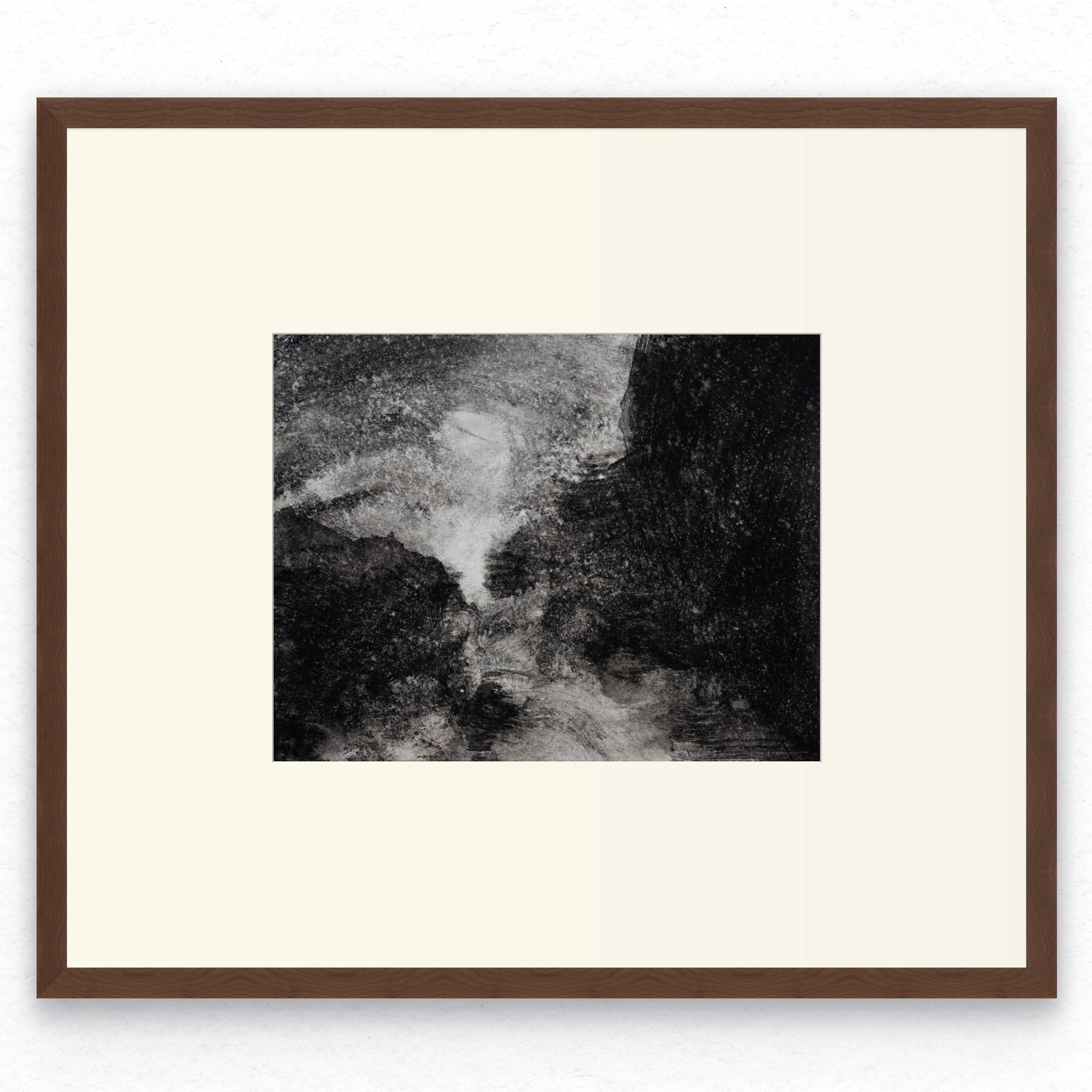 Shore 09 by Nicolas De Jesus — liquid charcoal and water on paper, waves crashing against rocks with two dark rock masses framing a narrow channel of spray and light, hardwood frame with mount