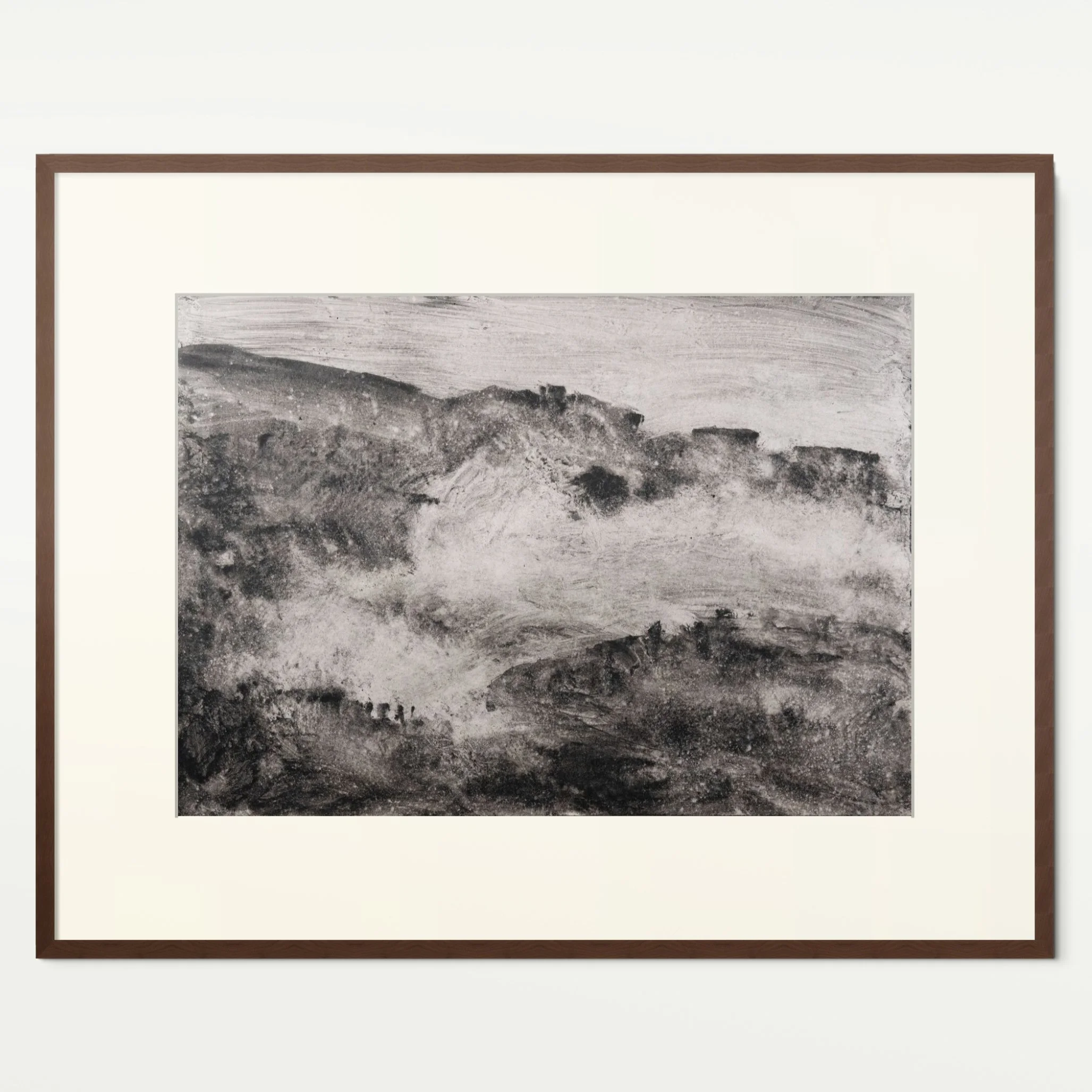 Shore 10 by Nicolas De Jesus — liquid charcoal and water on paper, waves crashing against rocks rendered as a long ridge of dark rock with a sweeping band of white spray across the middle, hardwood frame with mount