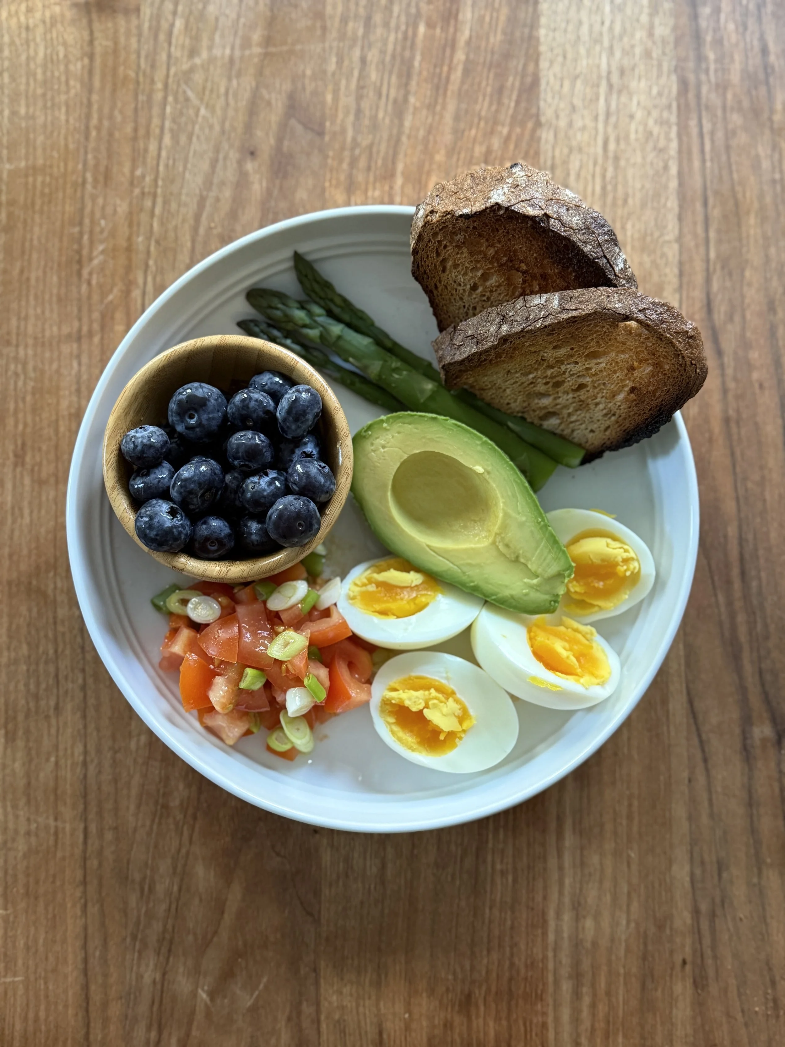 boiled eggs, with asparagus, avocado, tomatoes with spring onion, gluten free toast and blueberries