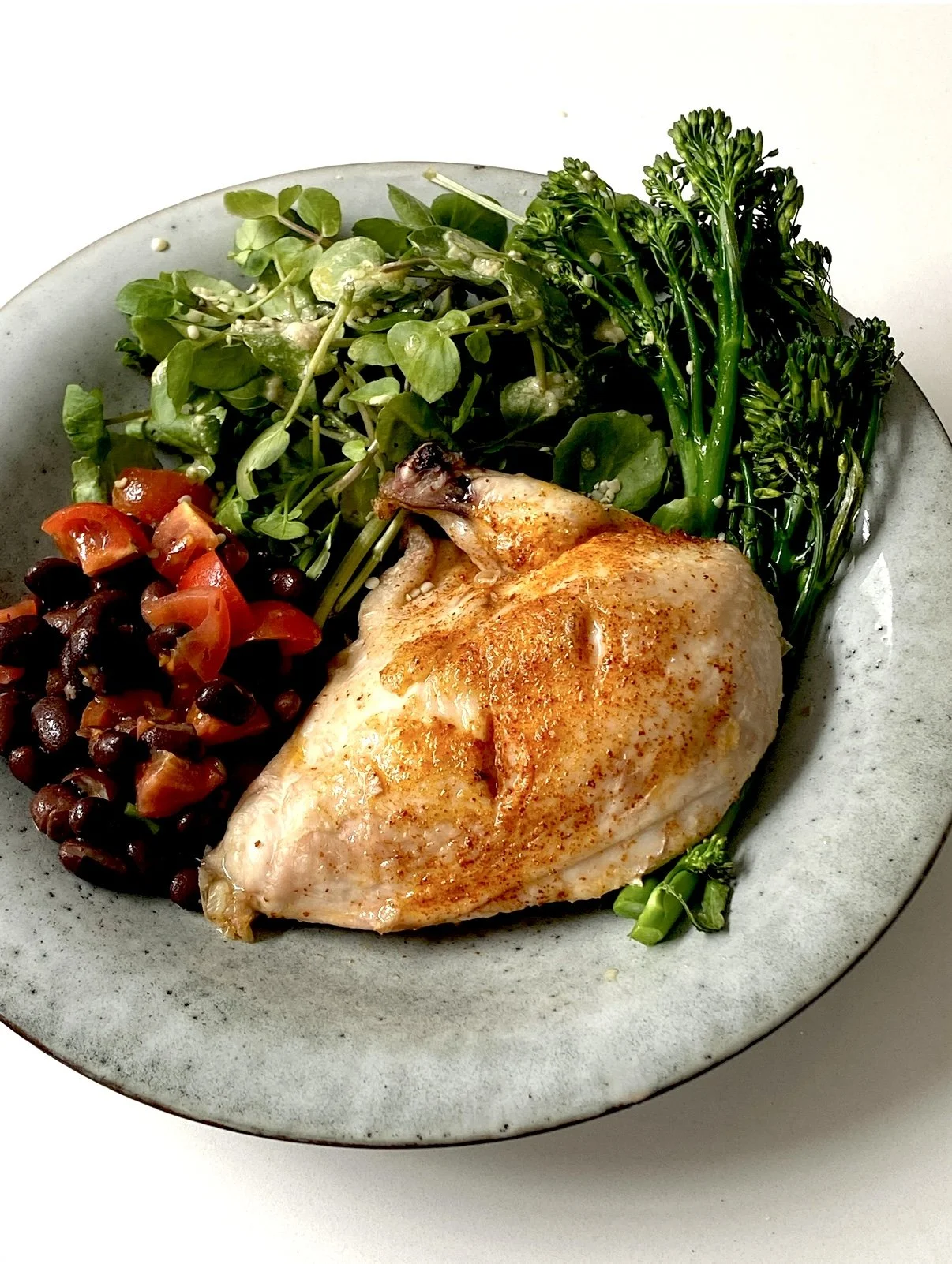 Paprika chicken with black beans and tahini greens
