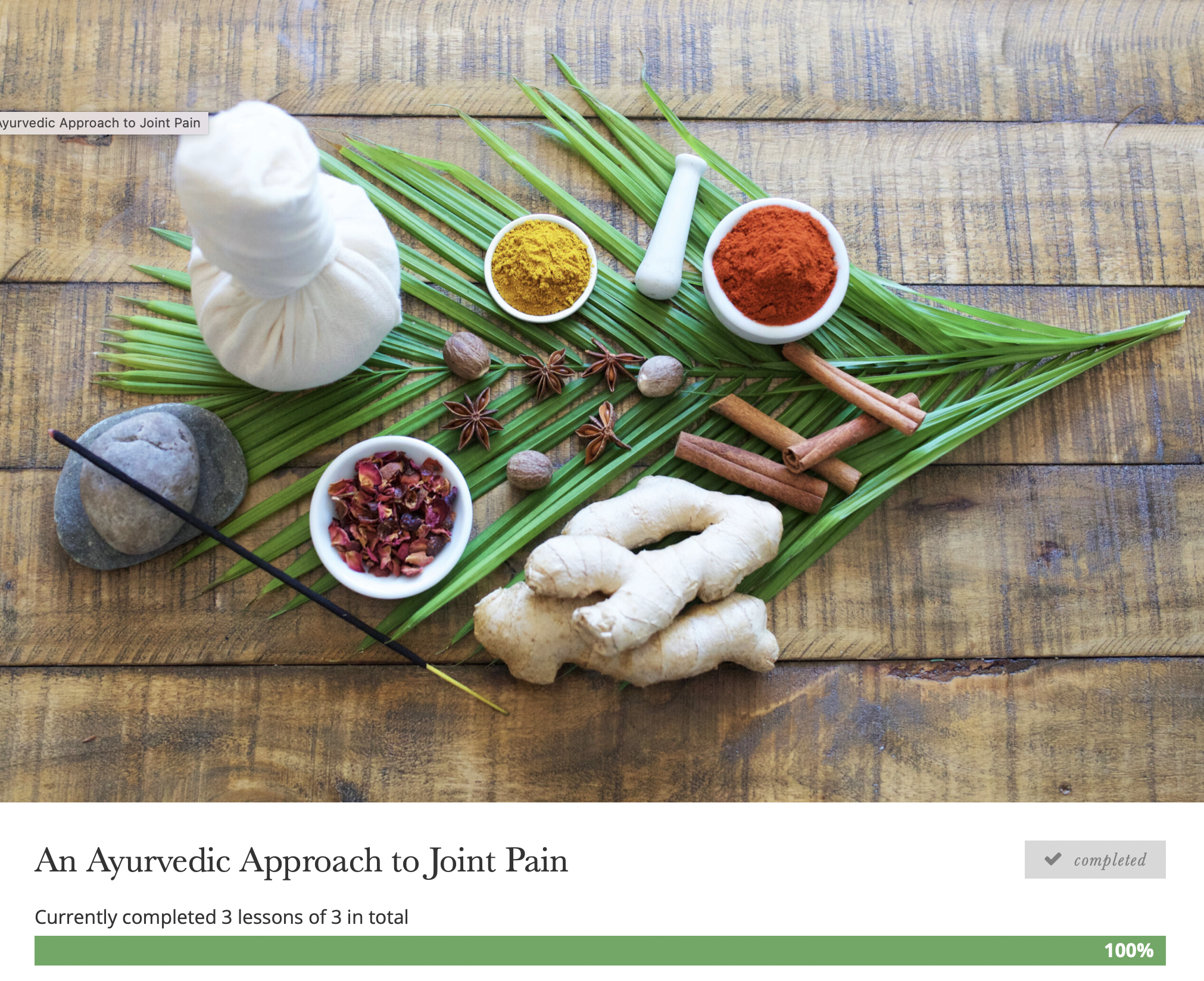 A wooden table with green palm leaves laid out, displaying a white herbal compress, a stone with two black sticks, a small bowl of dried rose petals, a small bowl of turmeric powder, a small bowl of red chili powder, several cinnamon sticks, a piece 