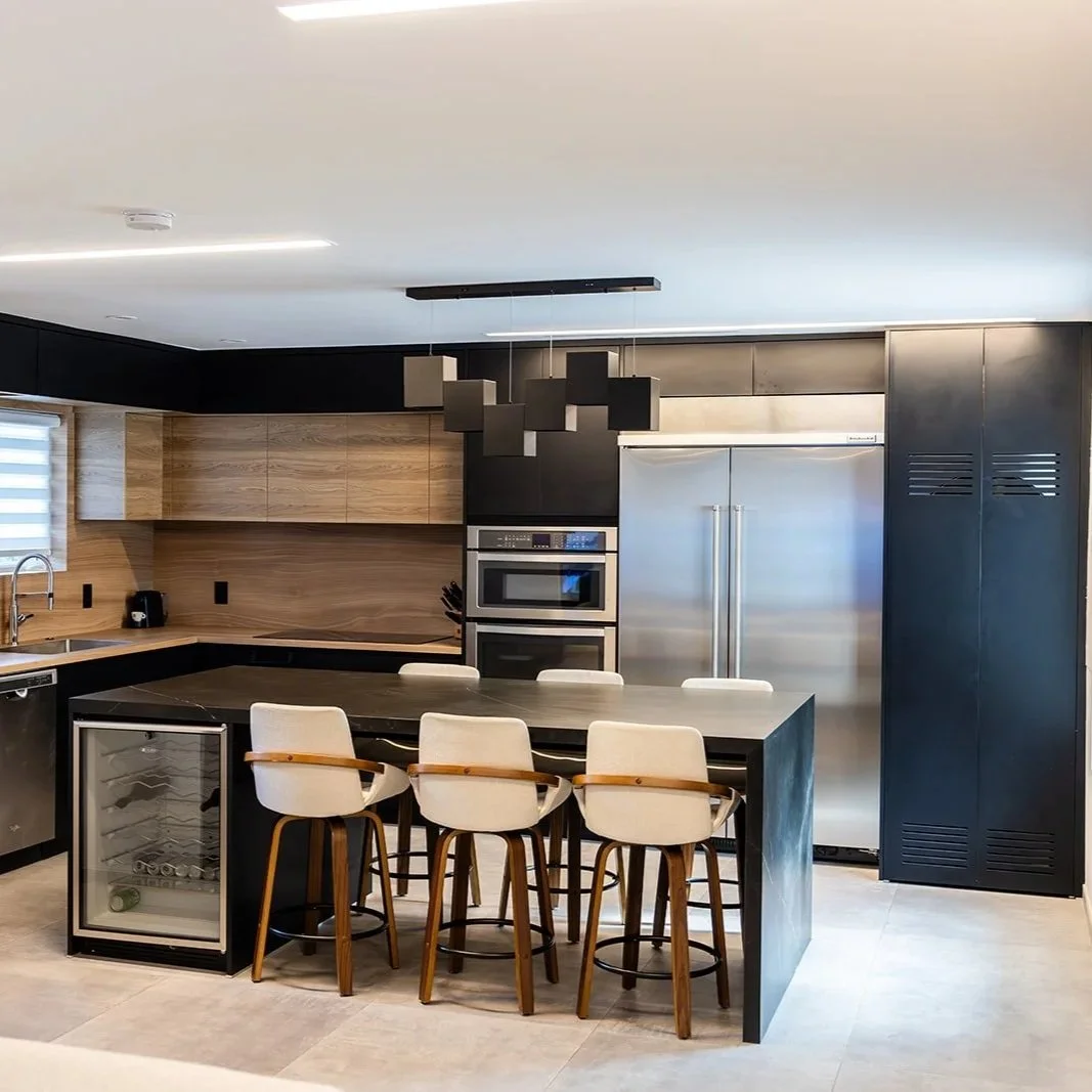 High-end modern kitchen renovation in Grand Cayman featuring a marble waterfall island and custom cabinetry.