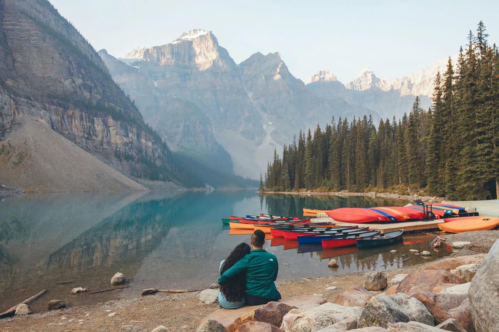 153_Couple-Sitting-By-Moraine-Lake-Banff-National-Park.webp
