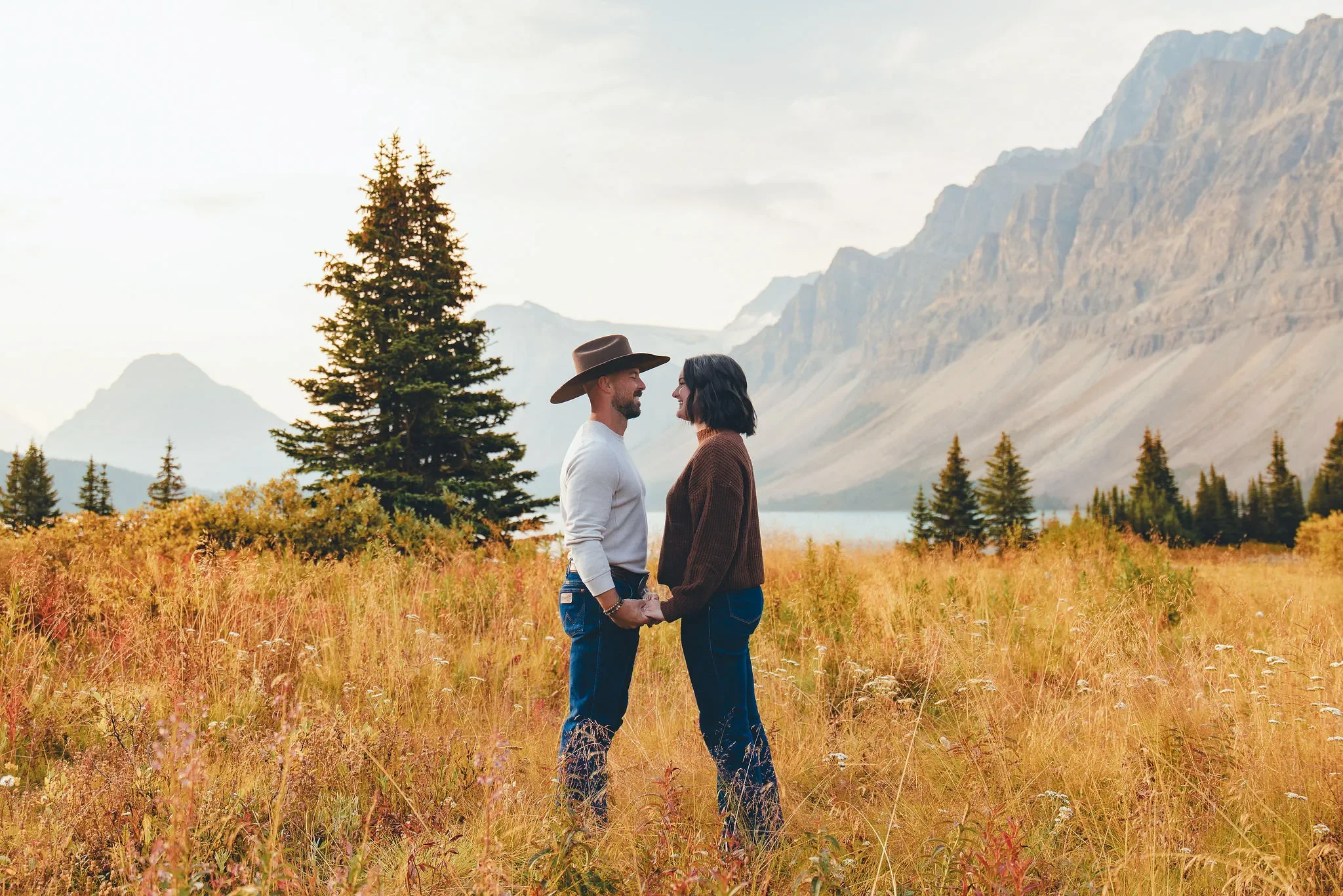 139_Couple-Holding-Hands-Mountain-Meadow-Canadian-Rockies-Golden-Hour.webp