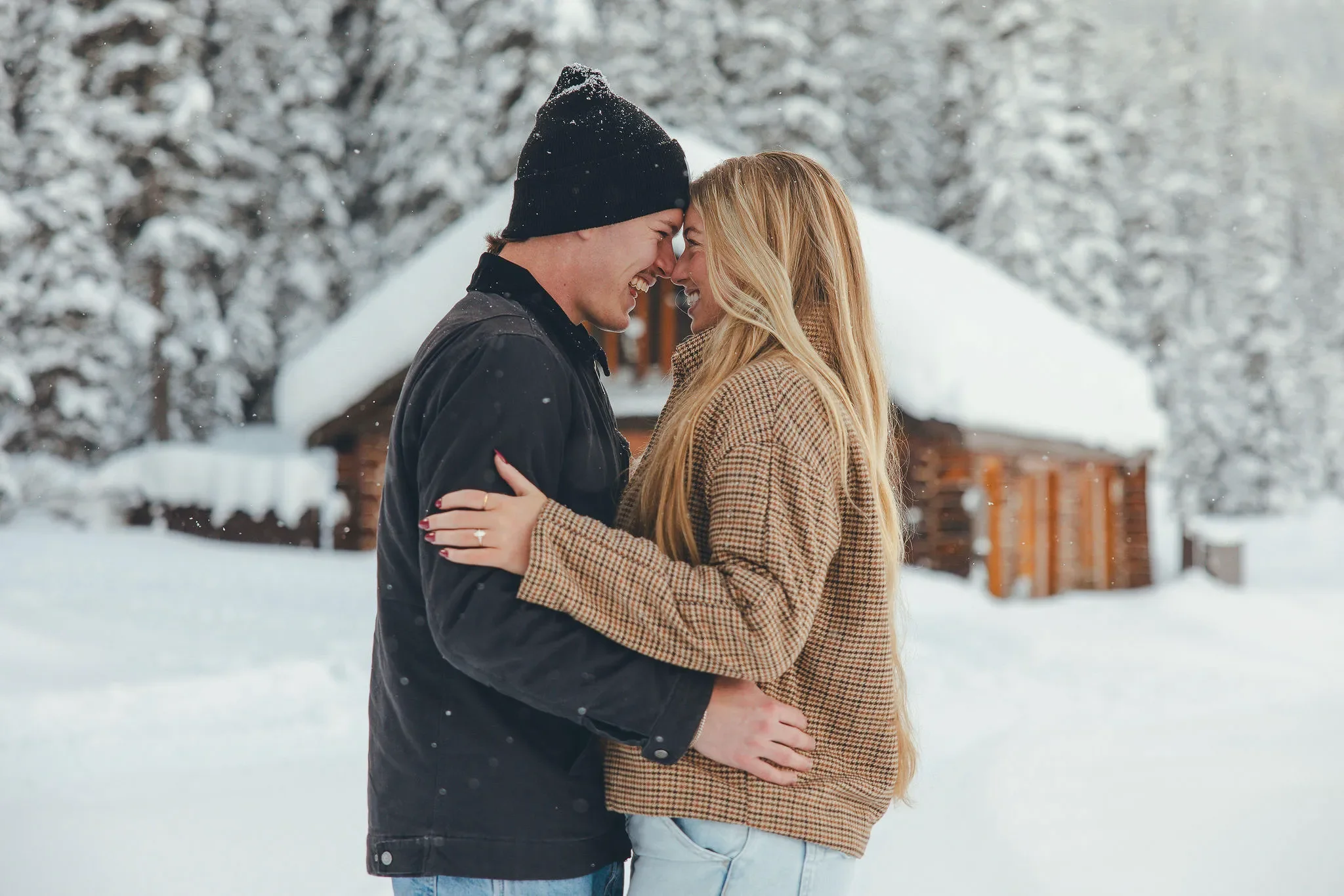 110_couple-engagement-portrait-snowy-mountain-landscape-chalet.webp