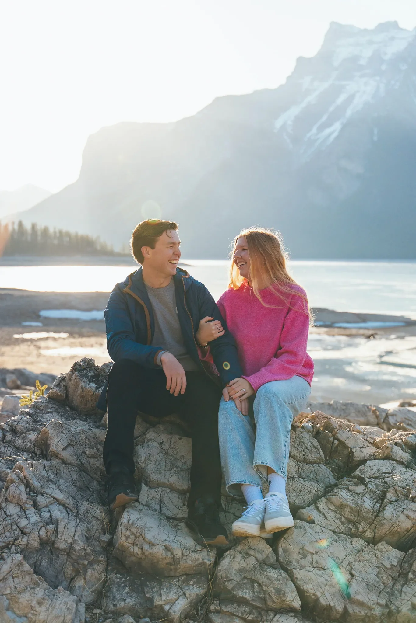 126_Laughing-Couple-Sitting-On-Rocks-Banff-Mountain-Landscape.webp
