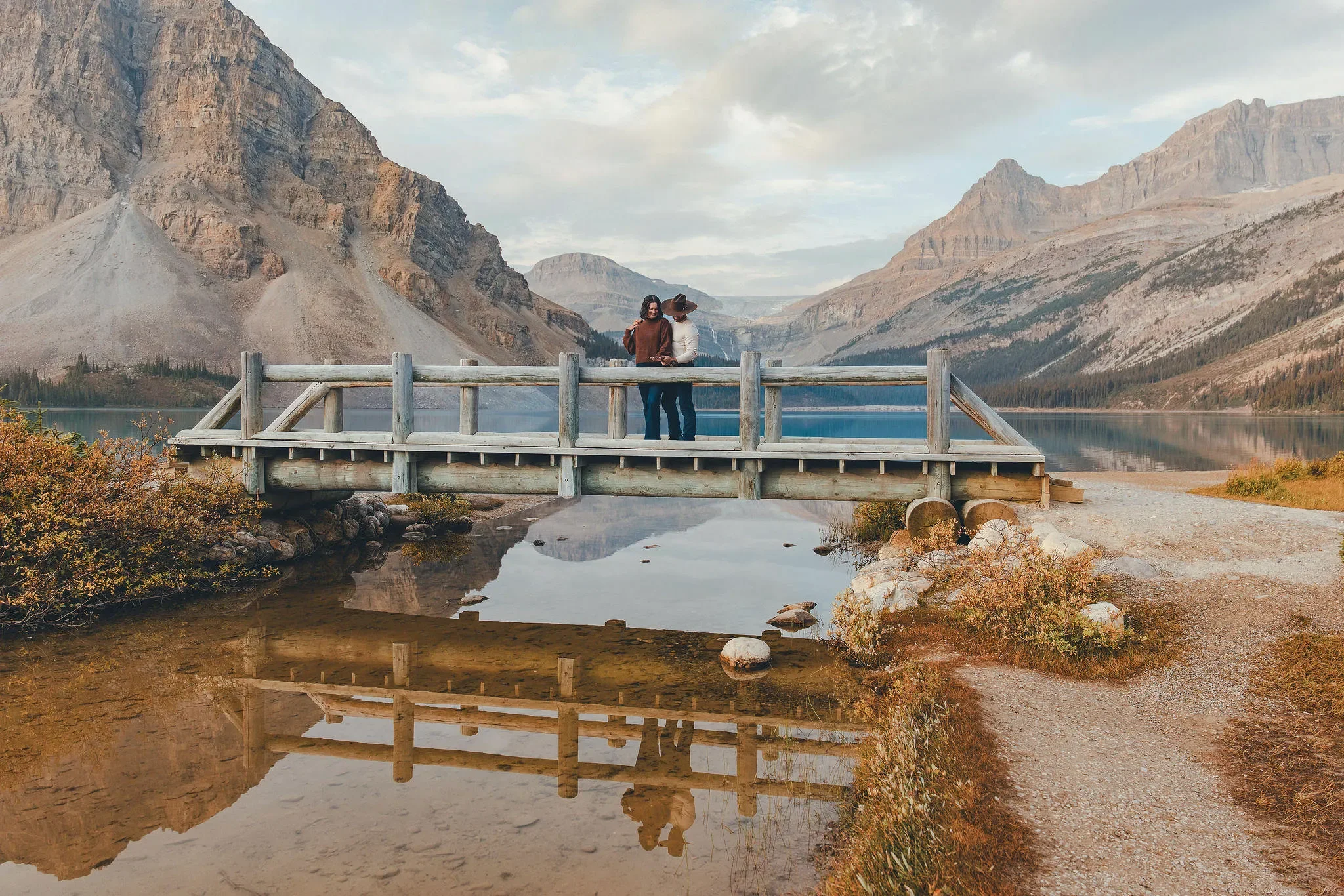 121_Couple-Embracing-Wooden-Bridge-Alpine-Lake-Banff.webp
