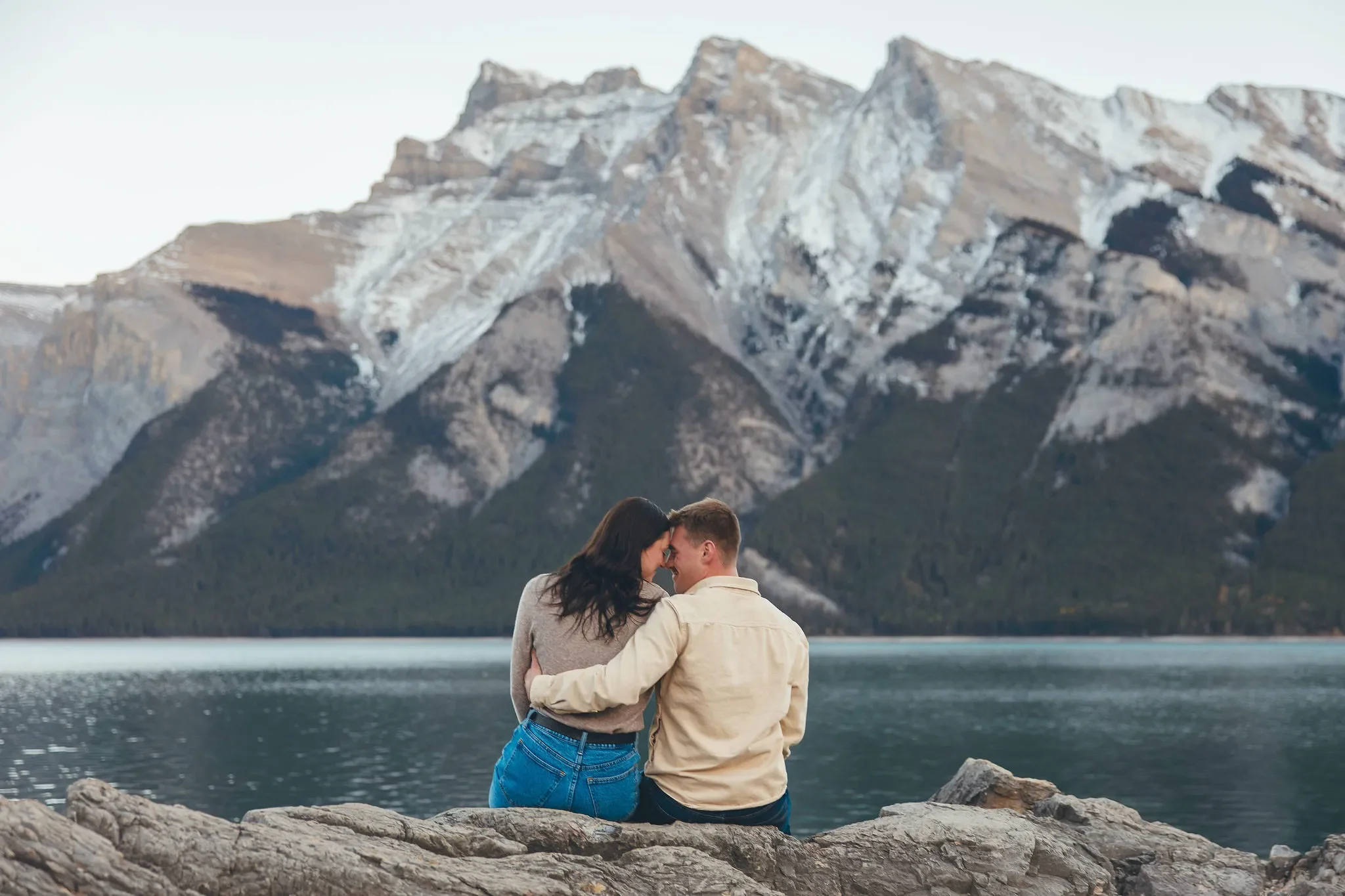 106_Couple-Sitting-Mountains-Alpine-Lake-Banff-National-Park.webp