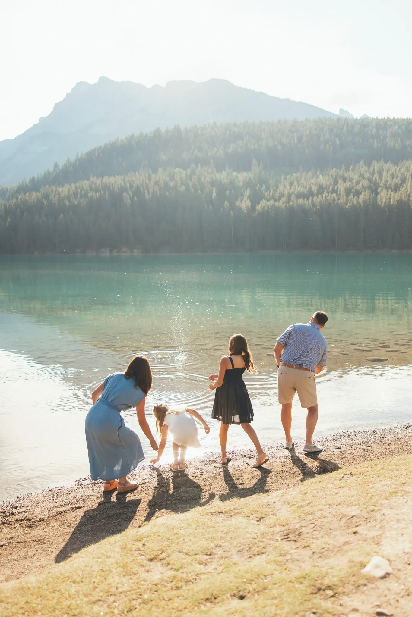 127_family-skipping-stones-alpine-lake-canadian-rockies.webp