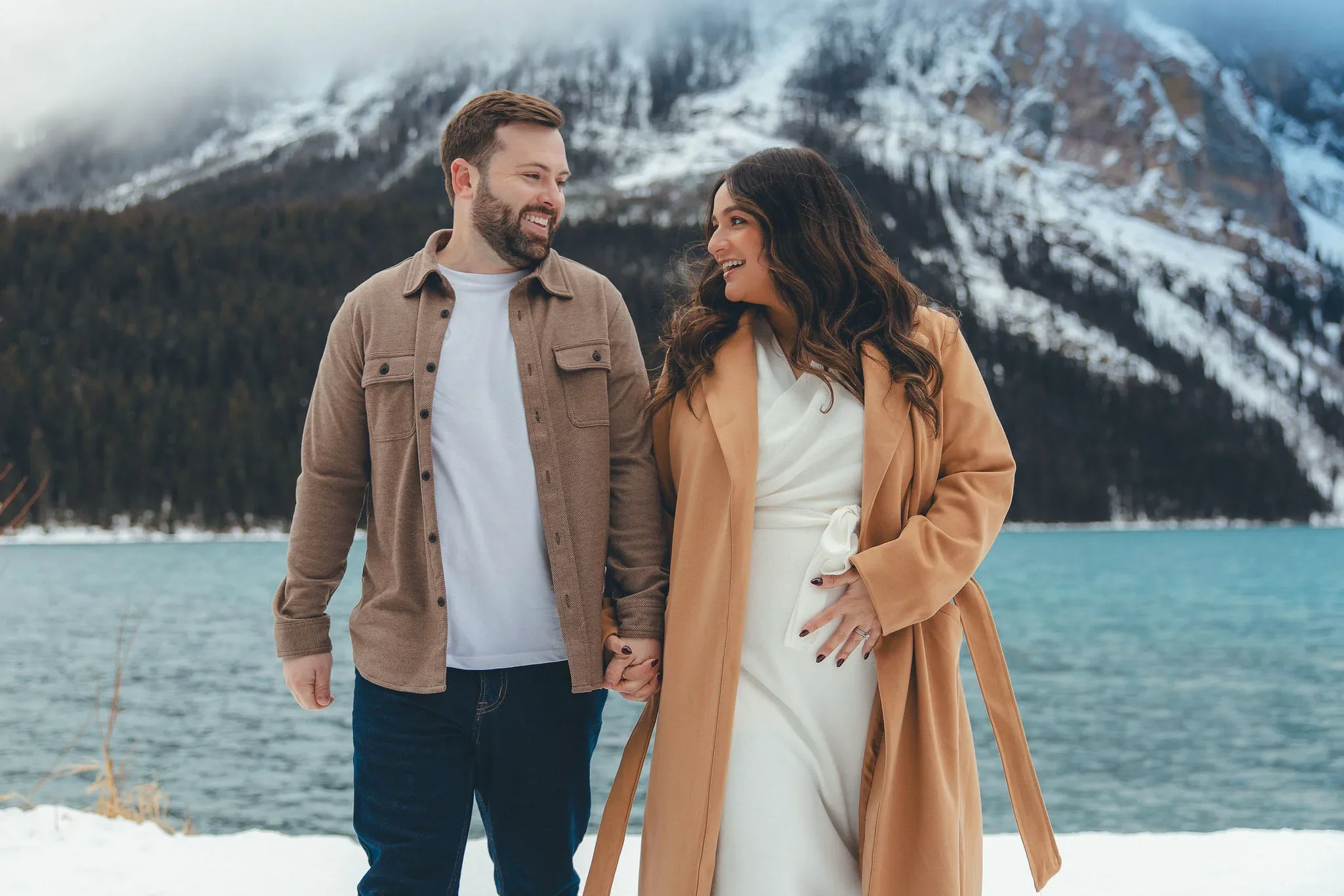 102_Maternity-Couple-Holding-Hands-Lake-Louise-Canadian-Rockies.webp