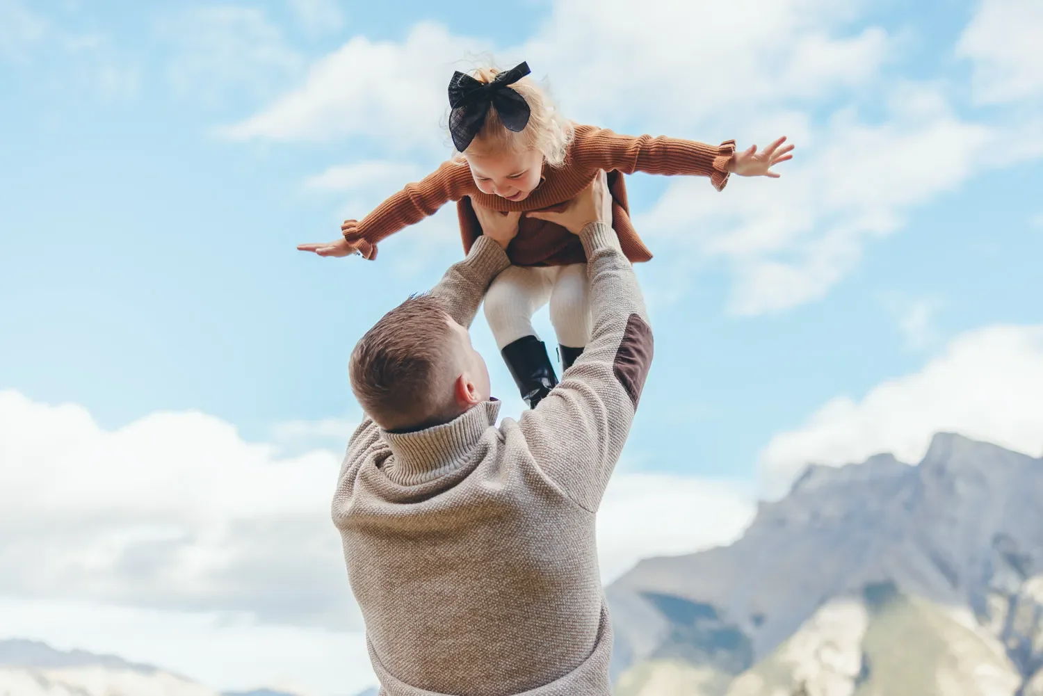 111_Family-Portrait-Father-Lifting-Child-Banff.webp