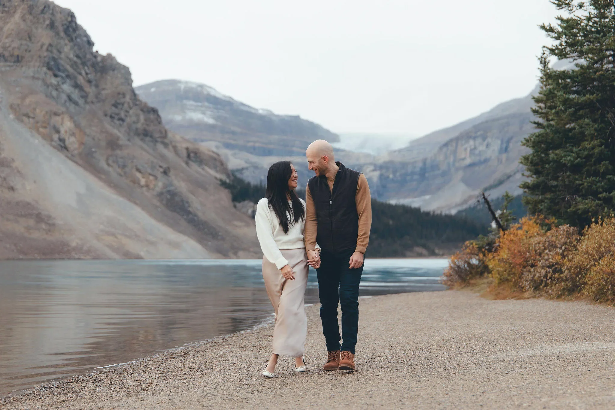 133_couple-walking-bow-lake-shoreline-banff-engagement.webp