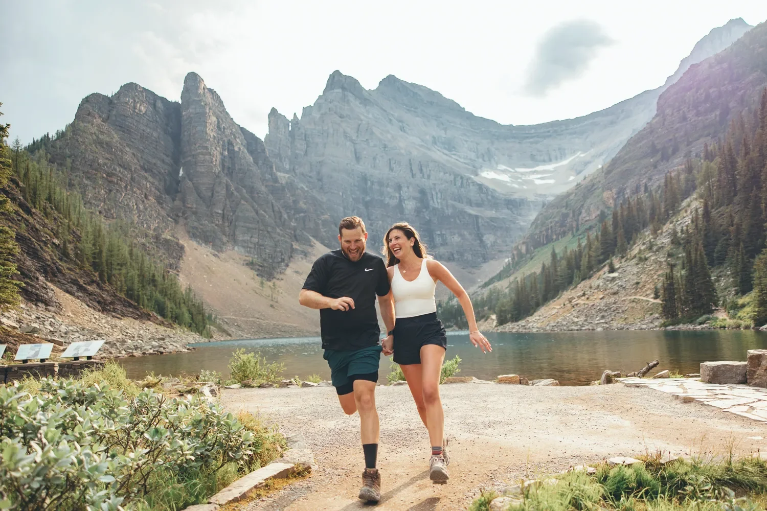 110_Couple-Running-Mountain-Trail-Lake-Louise.webp
