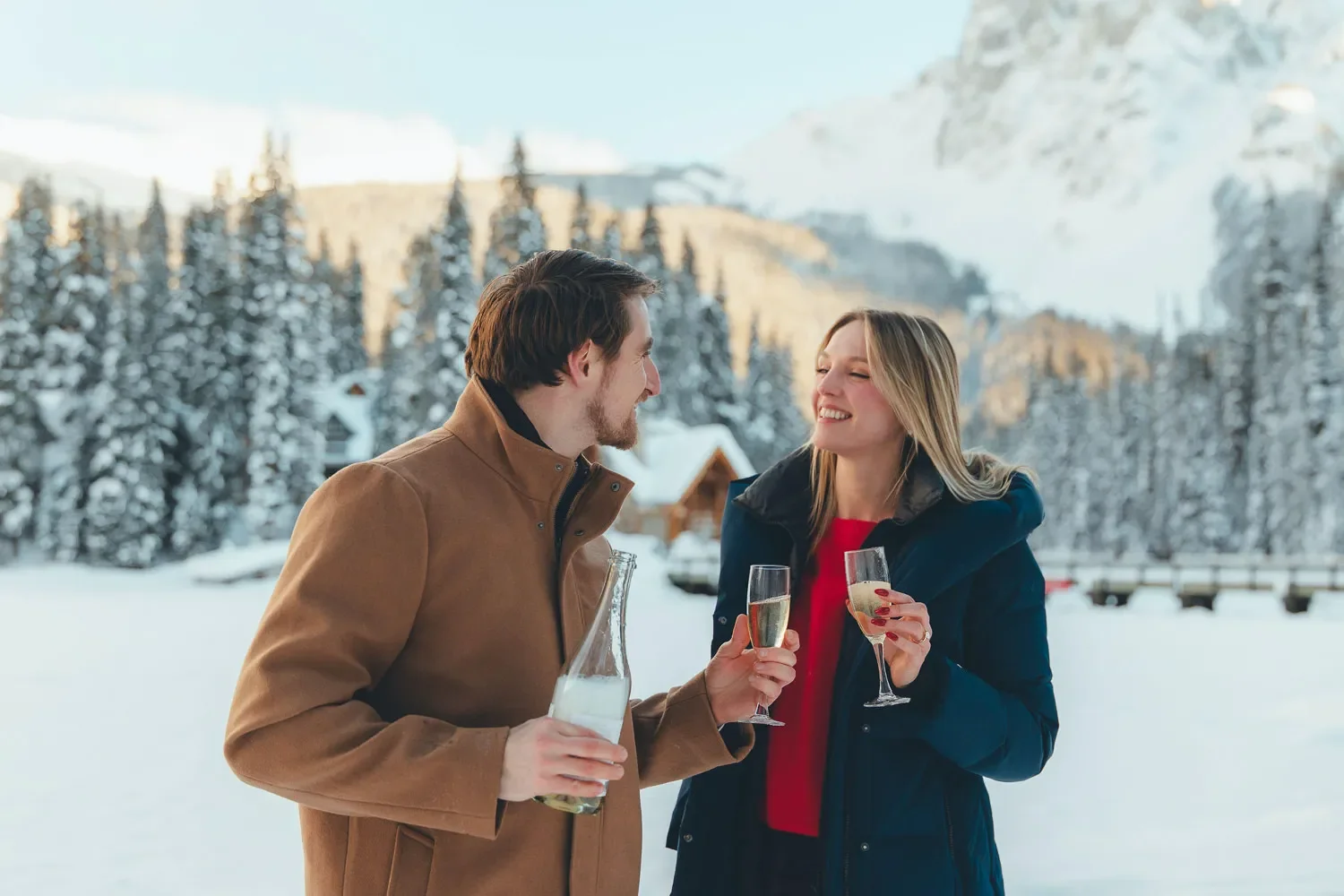 121_couple-toasting-champagne-winter-canadian-rockies.webp