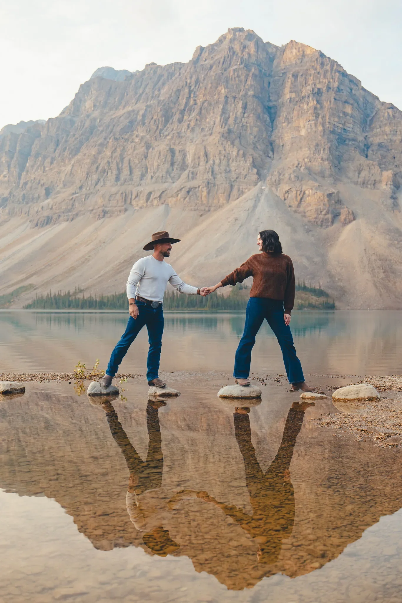 115_couple-holding-hands-alpine-lake-reflection-canadian-rockies.webp