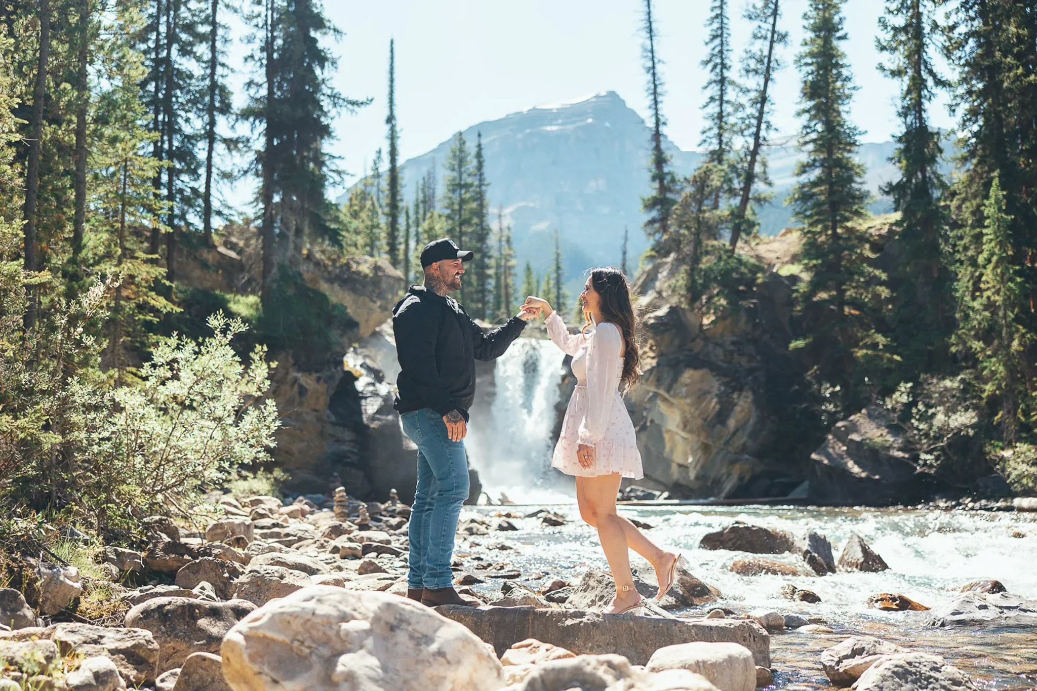 129_couple-holding-hands-waterfall-canadian-rockies.webp