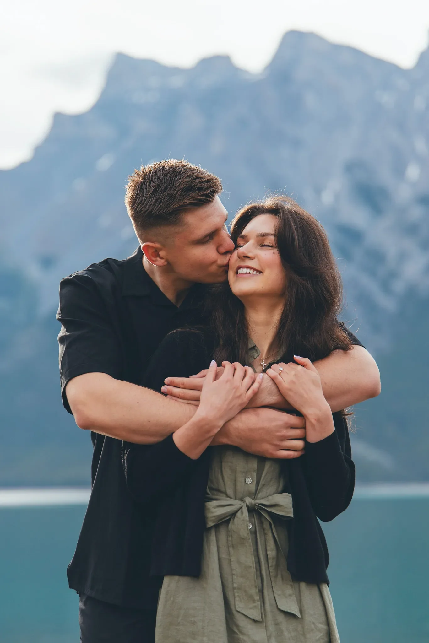 143_couple-engagement-portrait-embrace-canadian-rockies-lake.webp