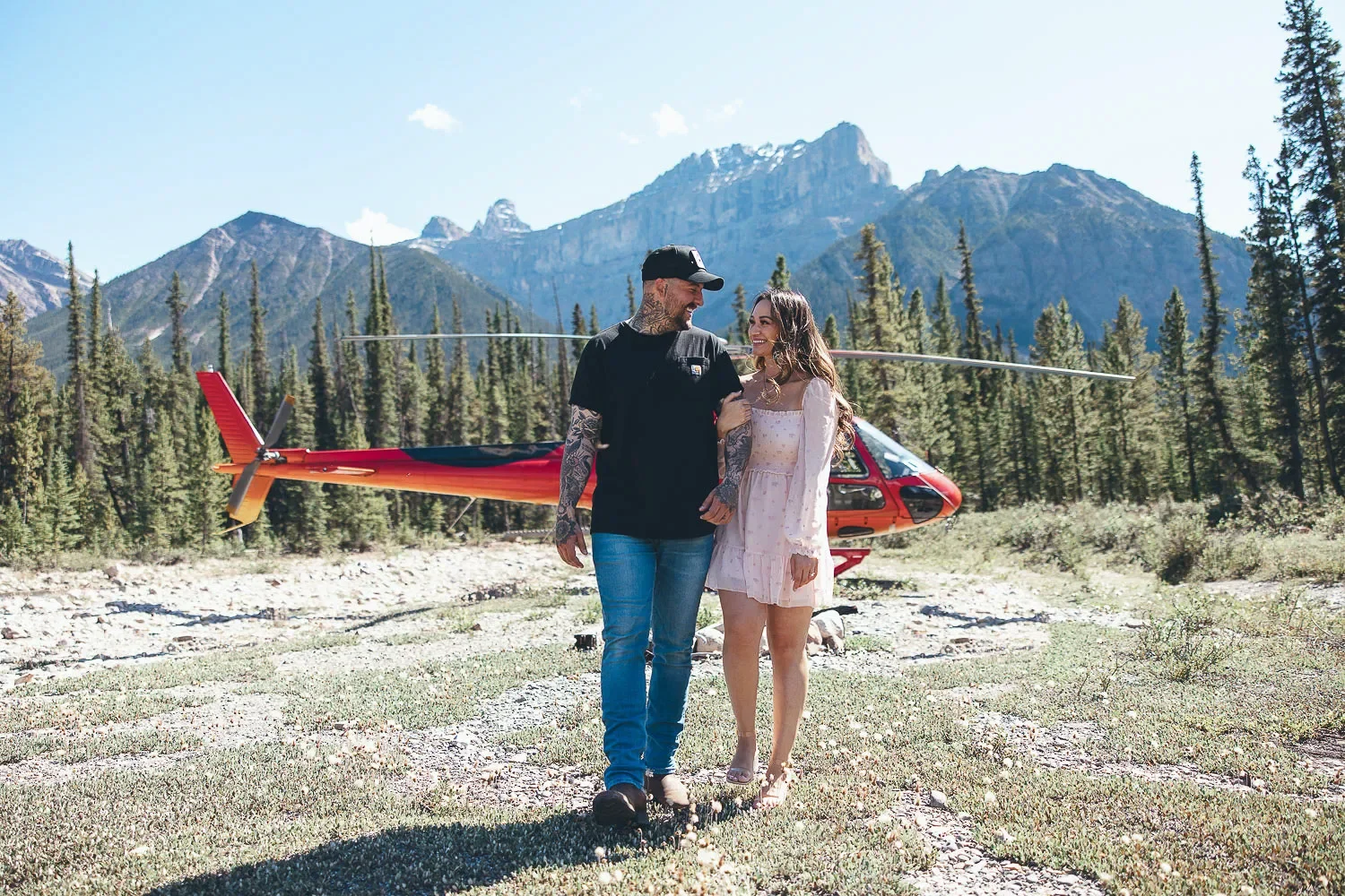 103_Couple-Walking-Engagement-Helicopter-Canadian-Rockies-Mountain-Landscape.webp
