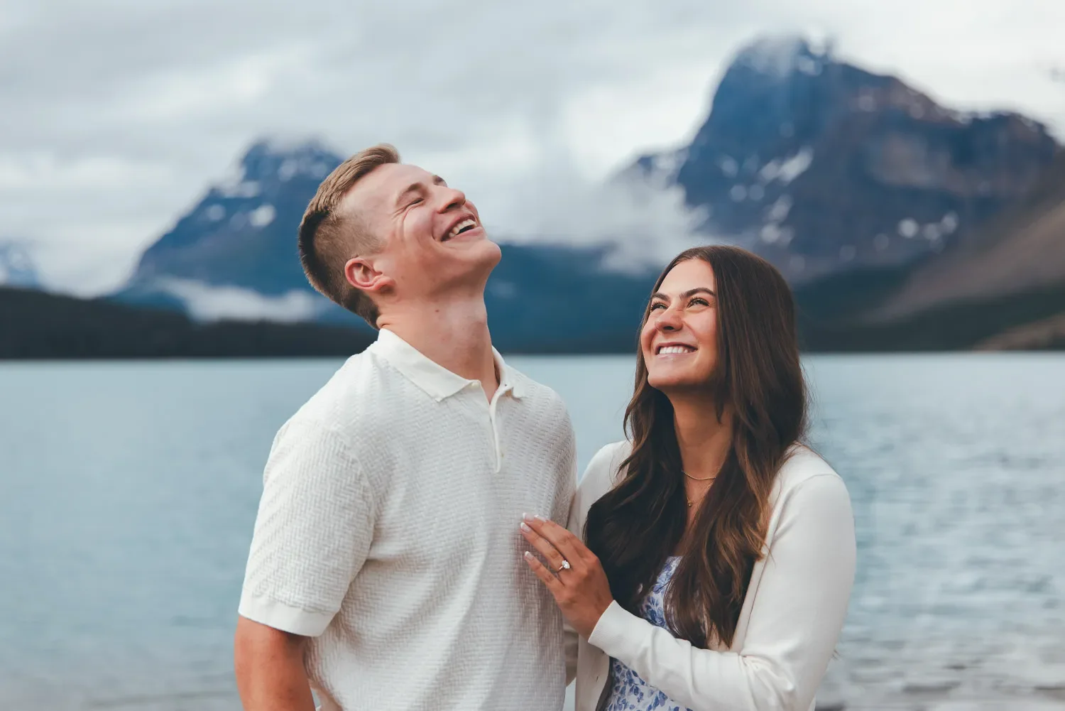 101_happy-couple-engagement-celebration-canadian-rockies-alpine-lake.webp