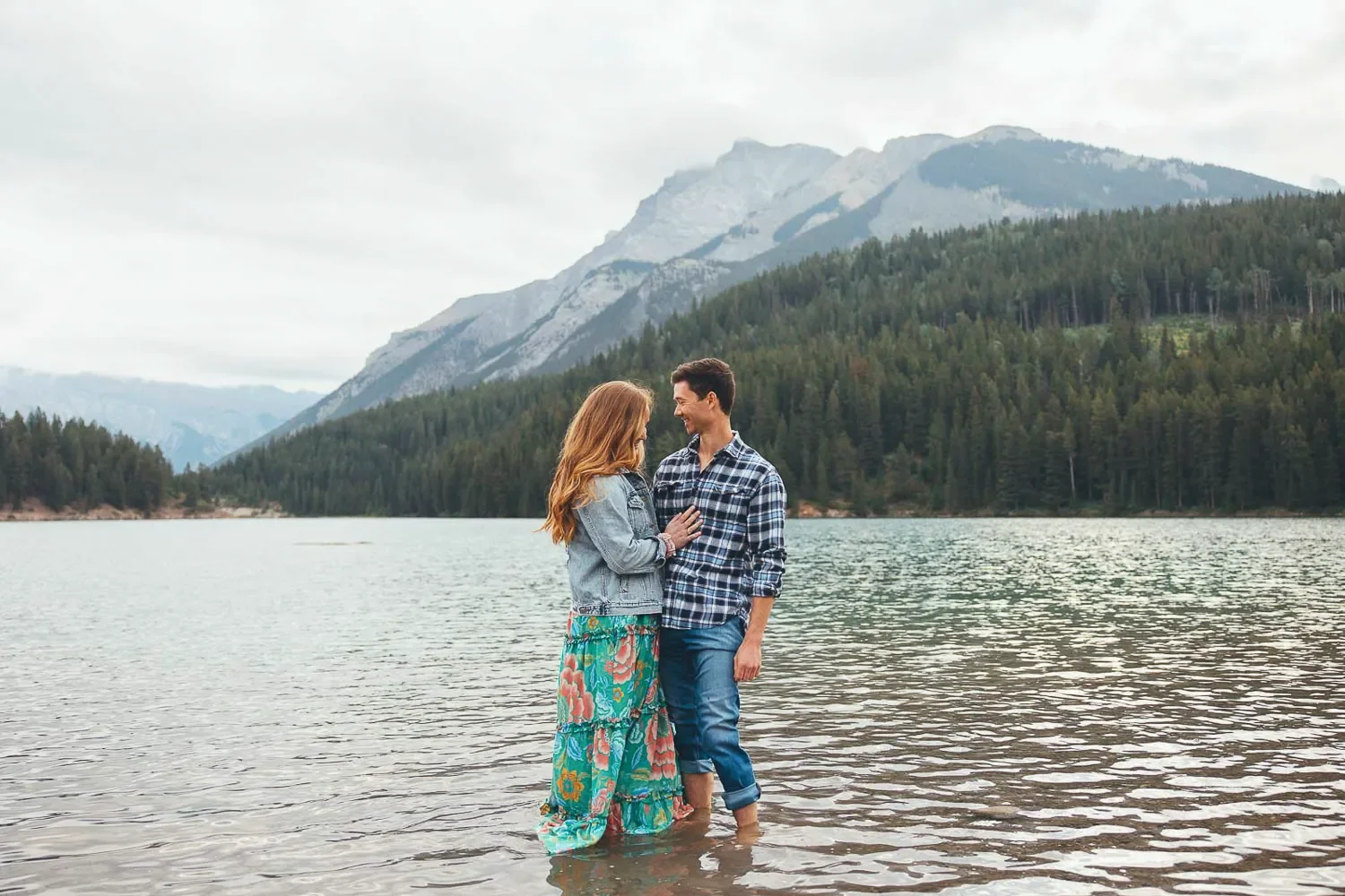 109_couple-standing-alpine-lake-canadian-rockies.webp