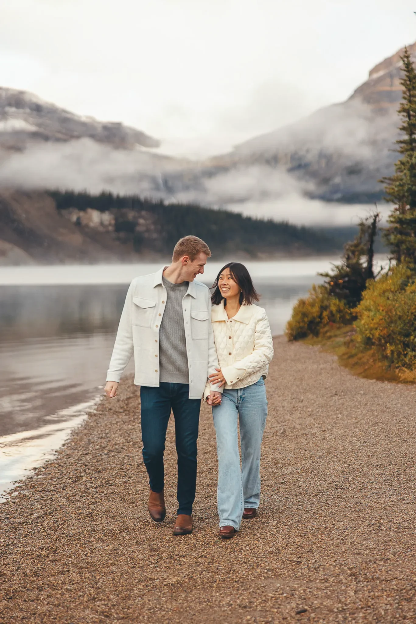 159_Couple-Walking-Hand-In-Hand-Alpine-Lake-Canadian-Rockies.webp