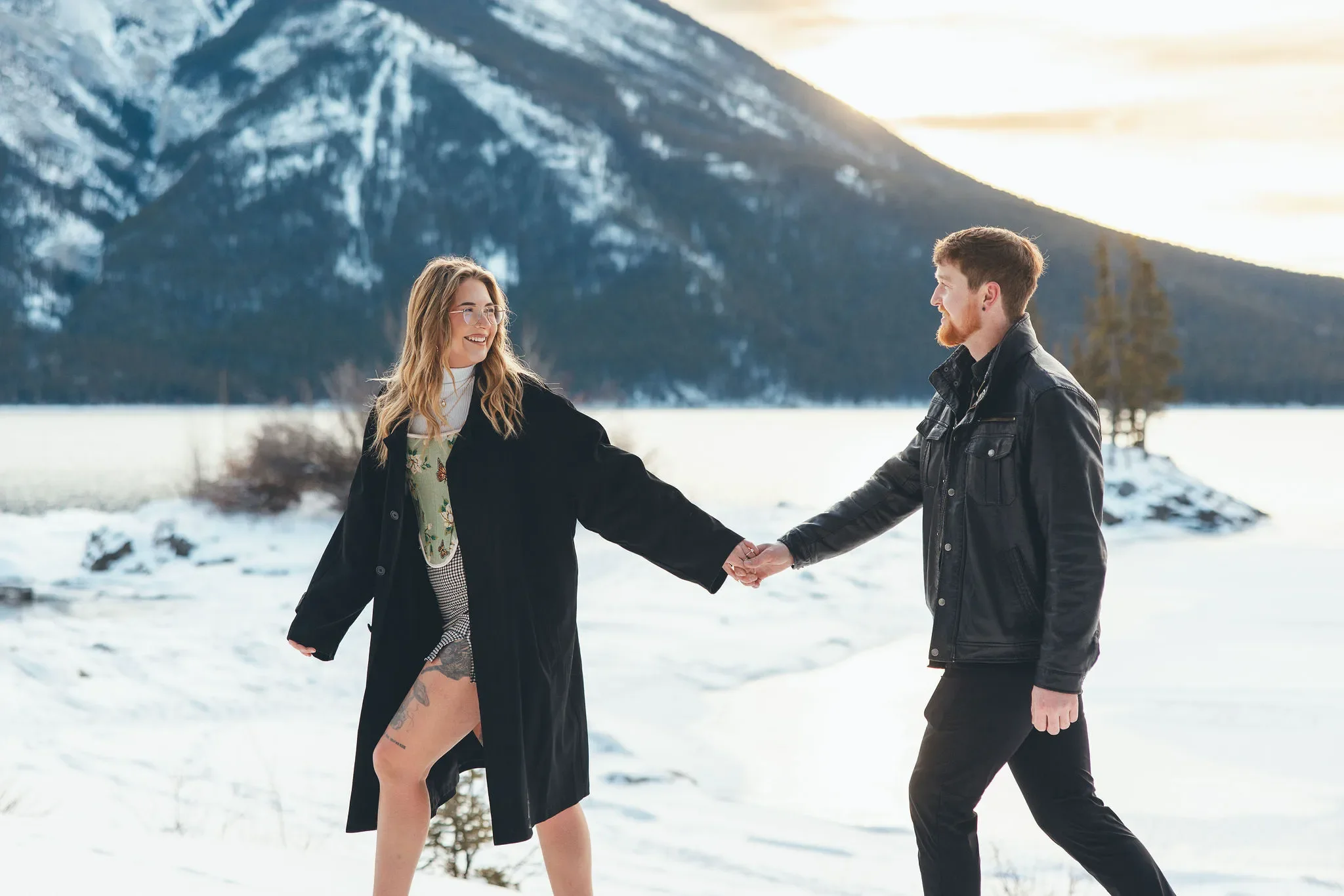 123_couple-walking-hand-in-hand-canadian-rockies-frozen-alpine-lake-sunset.webp