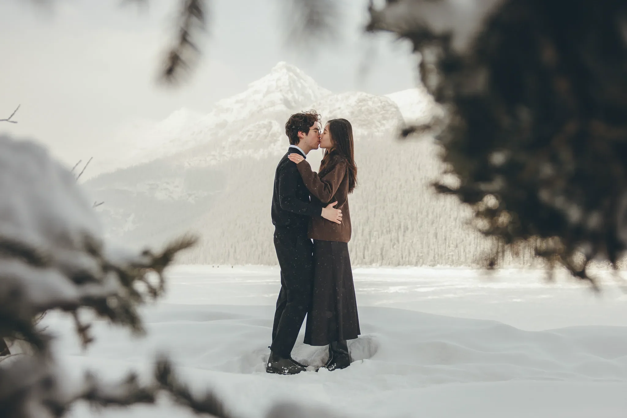 121_Couple-Kissing-Lake-Louise-Banff-Winter-Mountain-Landscape.webp