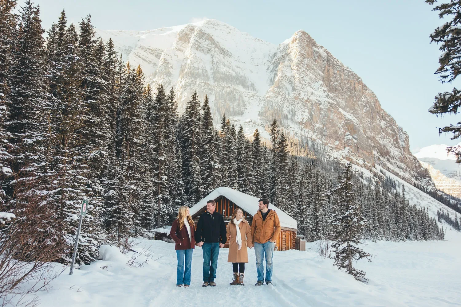 110_family-portrait-walking-snowy-mountain-trail-lake-louise.webp